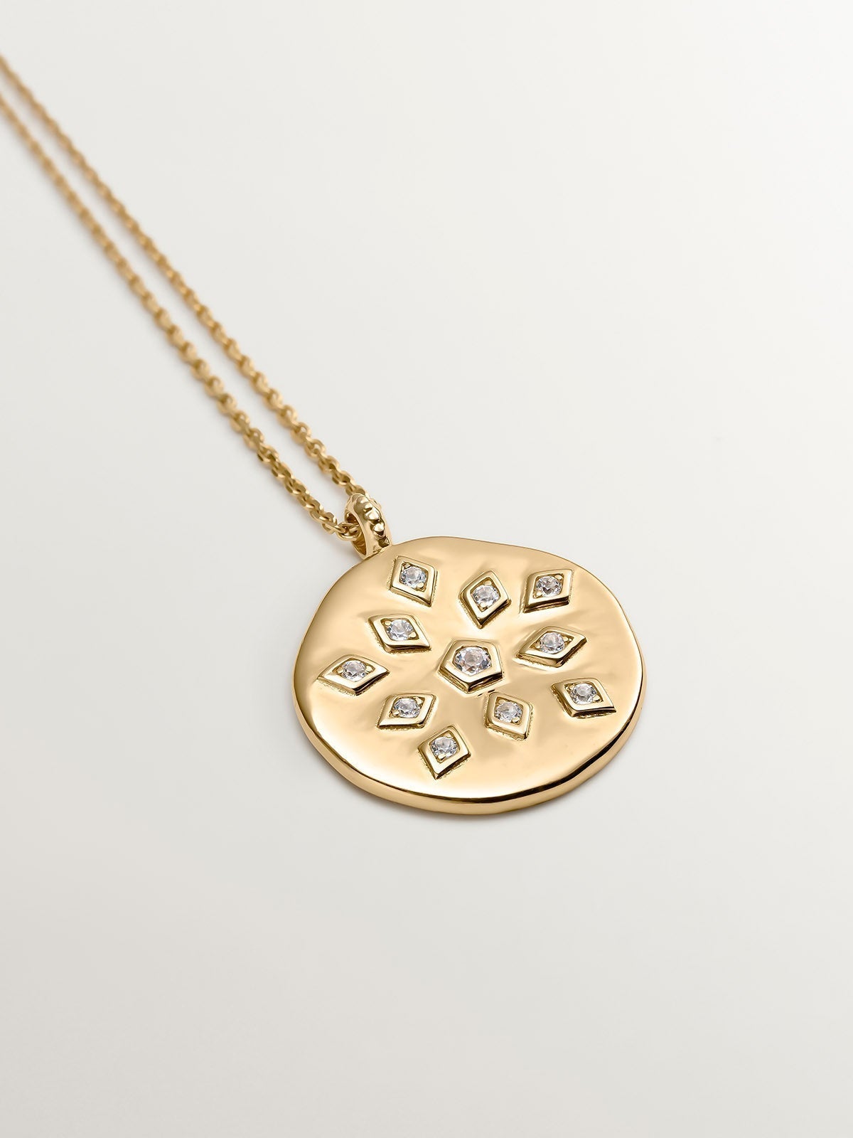 925 Silver pendant bathed in 18K yellow gold with medal and white topaz.