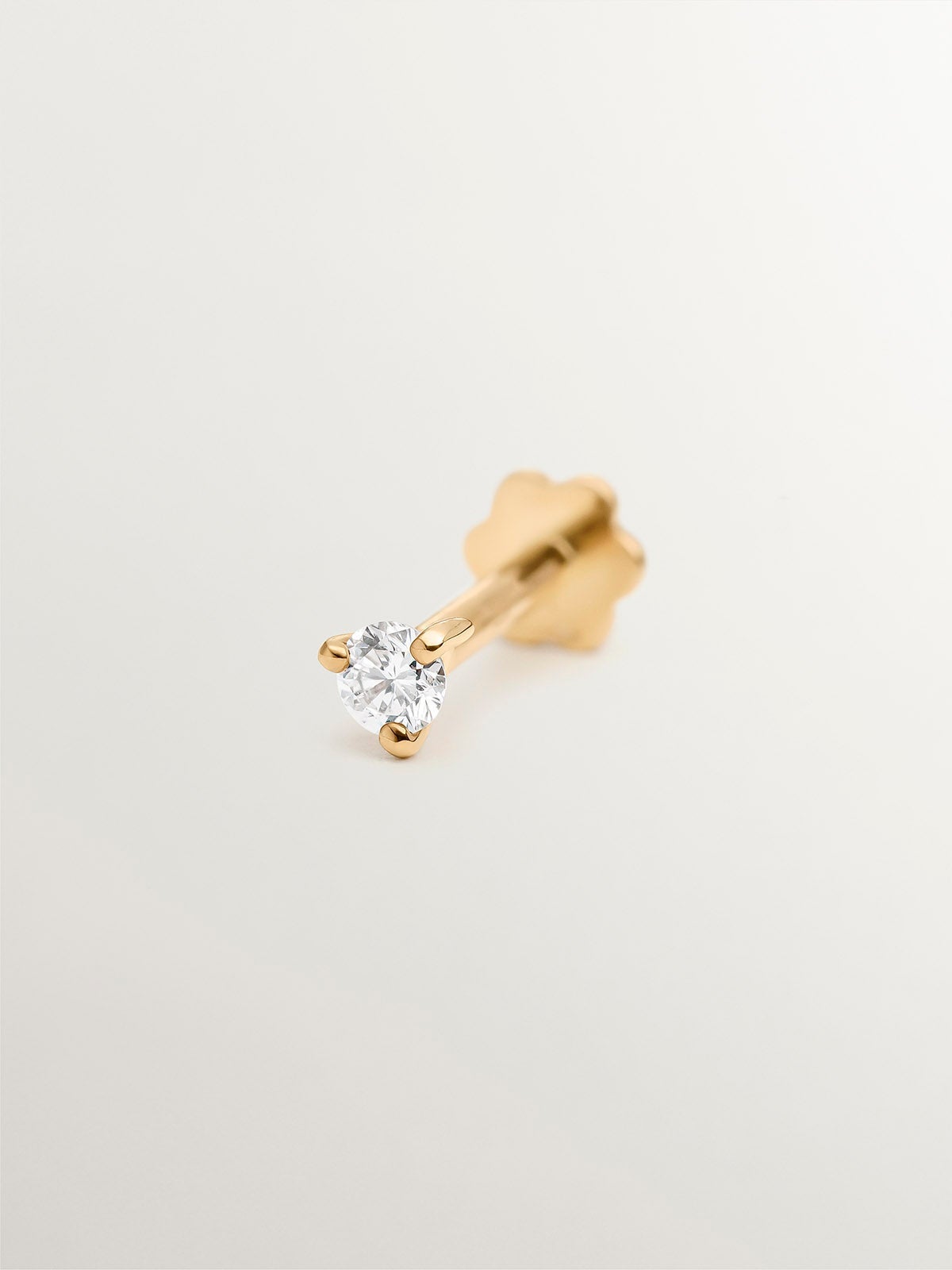 Single 18K yellow gold piercing with 0.04 cts diamond.
