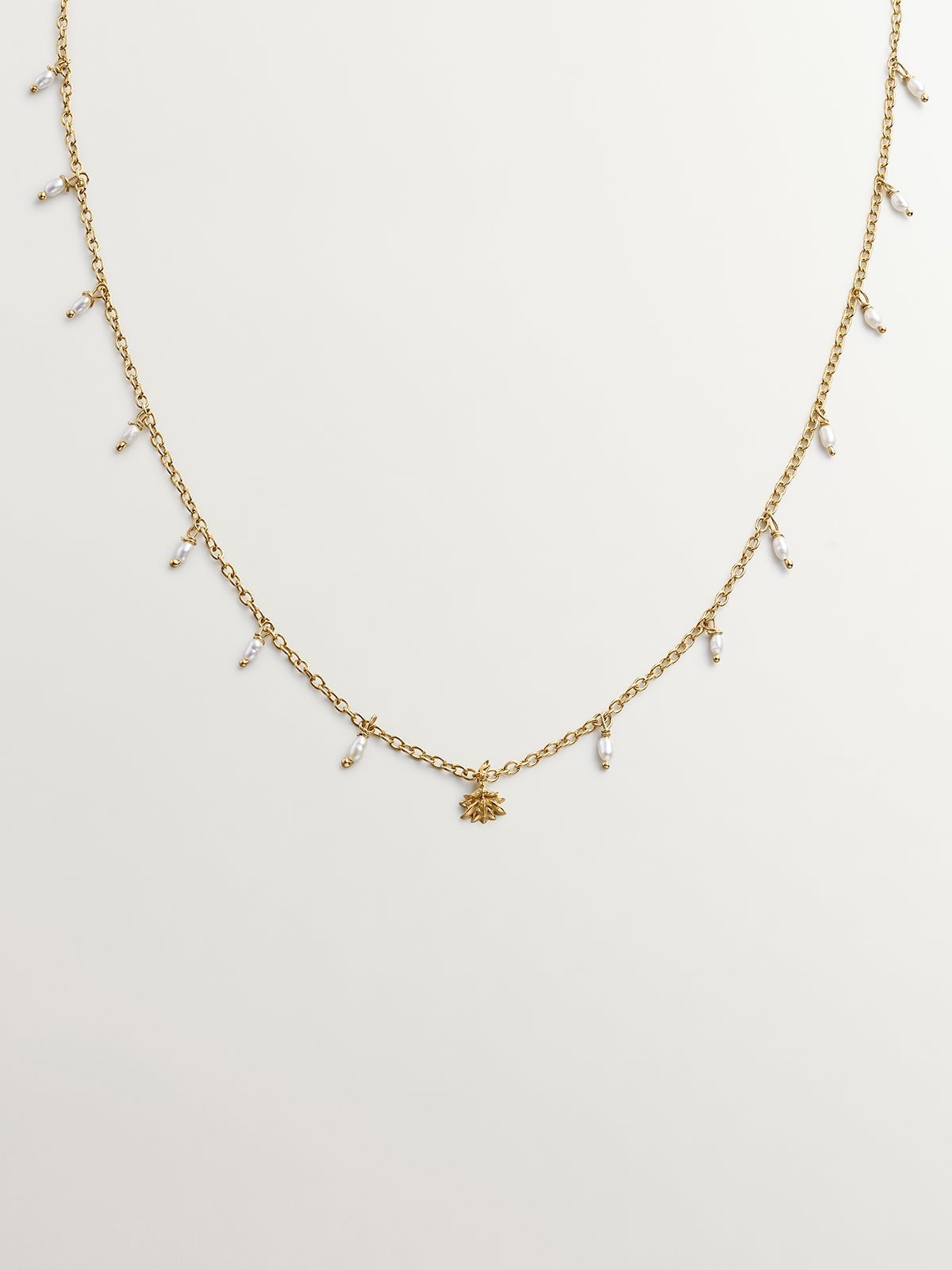 925 Silver necklace bathed in 18K yellow gold with river pearls and lotus flower.