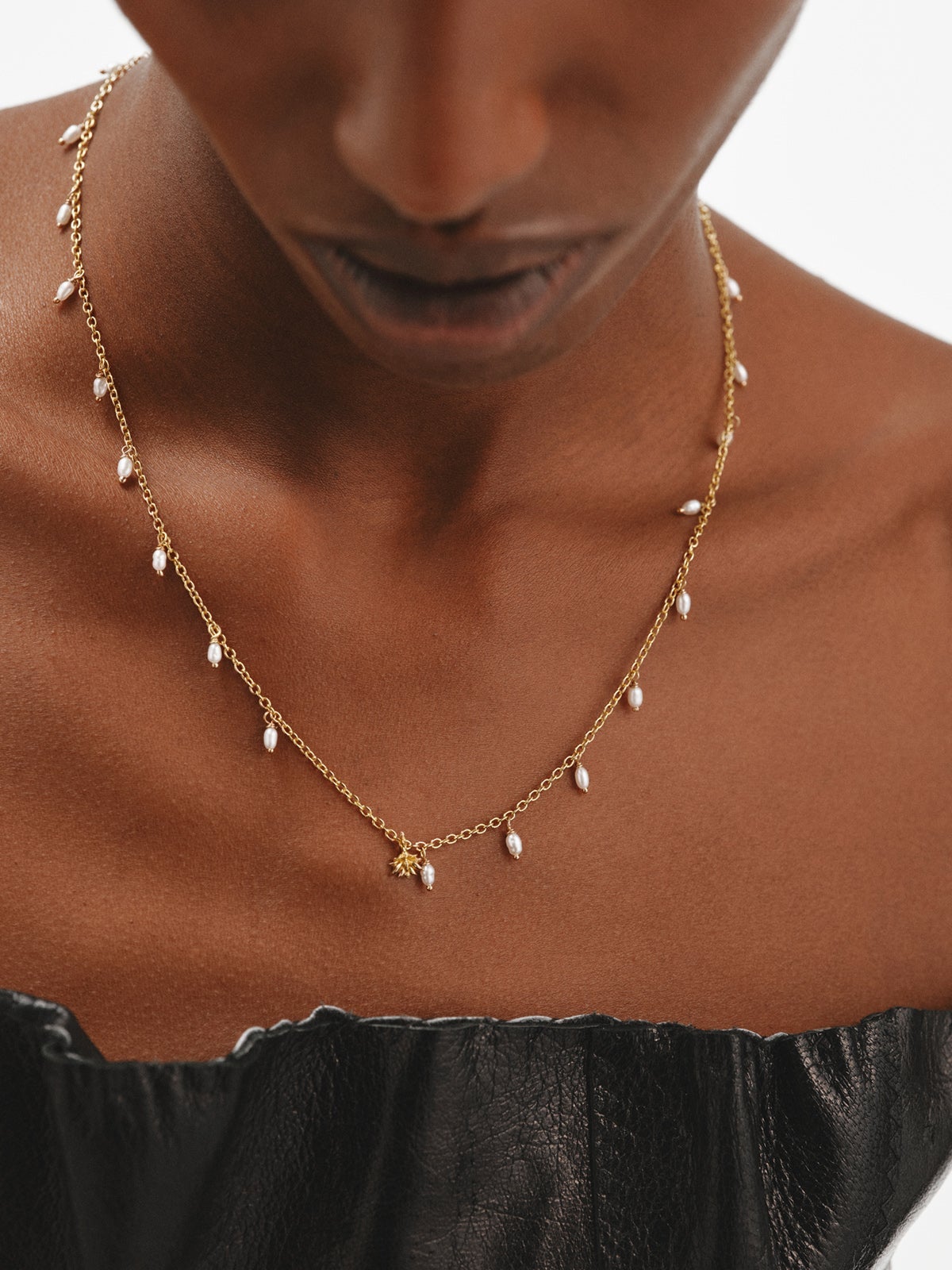 925 Silver necklace bathed in 18K yellow gold with river pearls and lotus flower.
