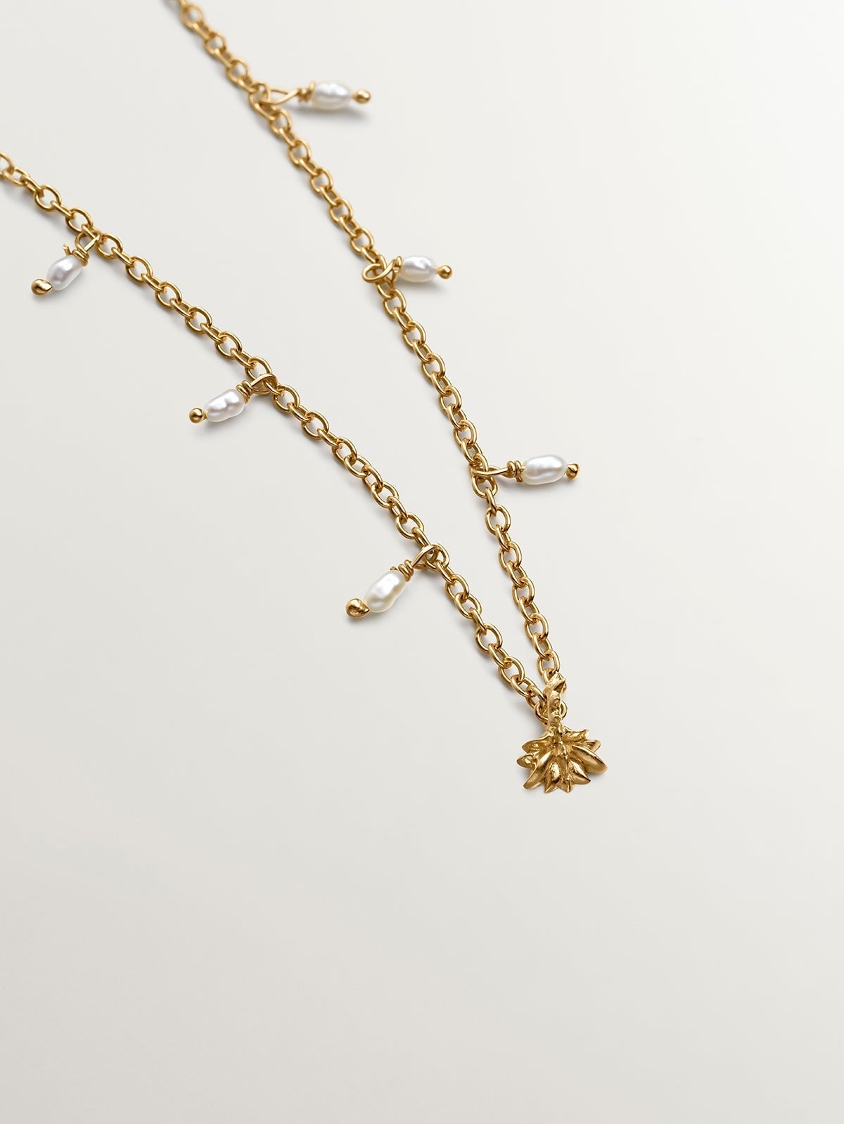 925 Silver necklace bathed in 18K yellow gold with river pearls and lotus flower.