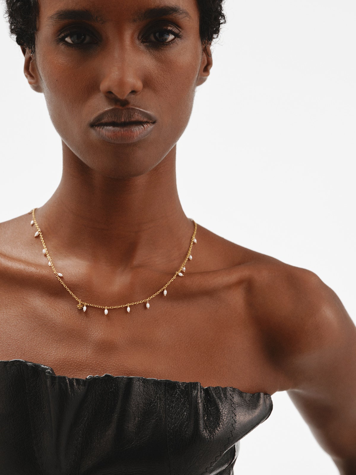 925 Silver necklace bathed in 18K yellow gold with river pearls and lotus flower.