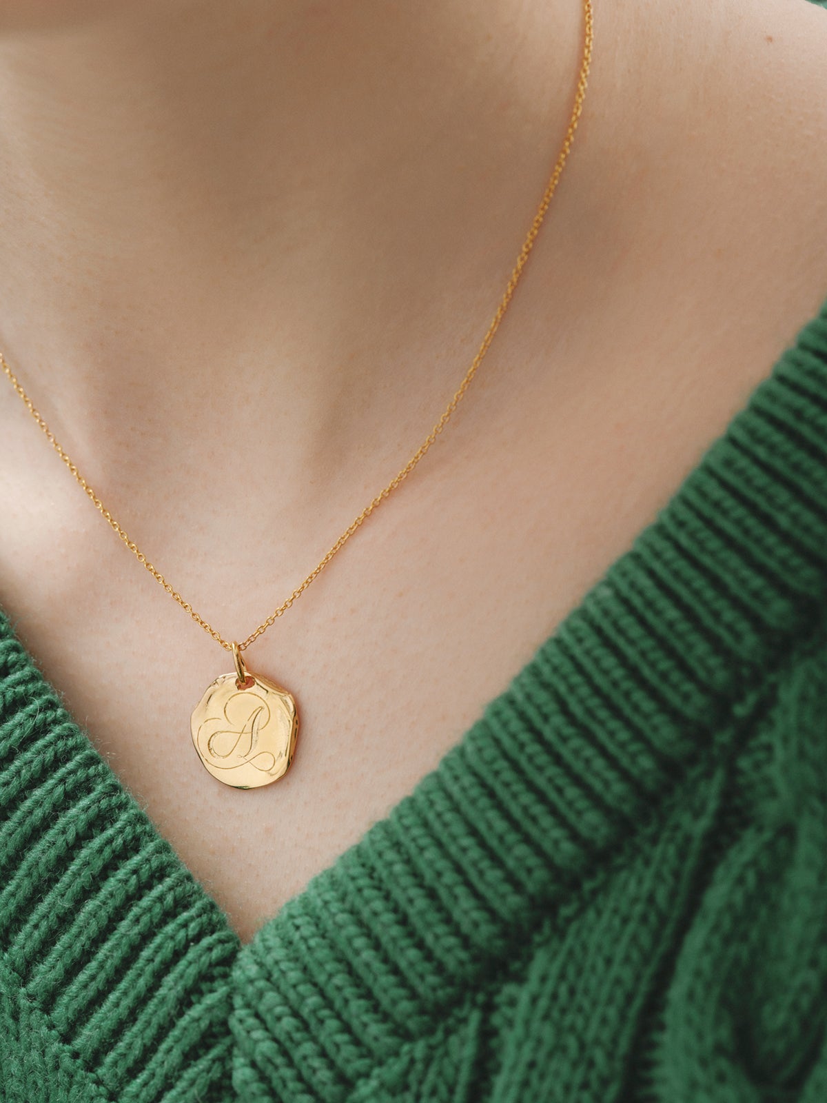 Handcrafted 925 silver charm bathed in 18K yellow gold with initial A.