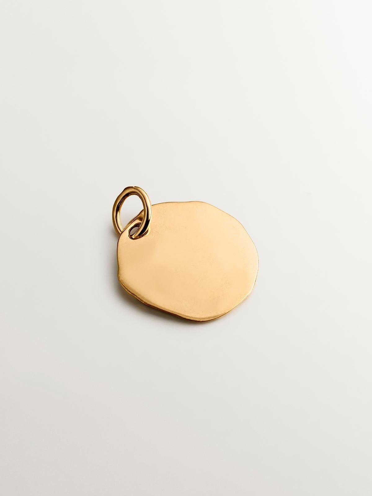 Handcrafted 925 silver charm bathed in 18K yellow gold with initial A.