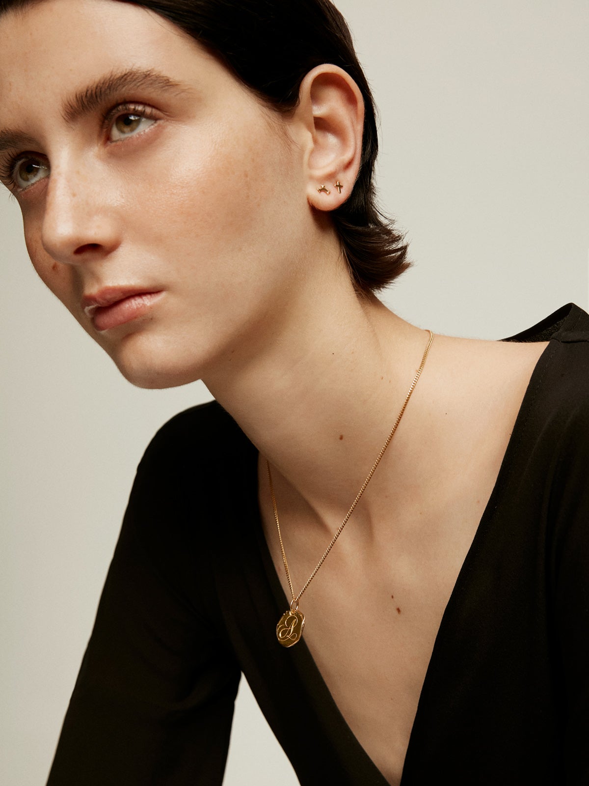 Handcrafted 925 silver charm bathed in 18K yellow gold with initial A.