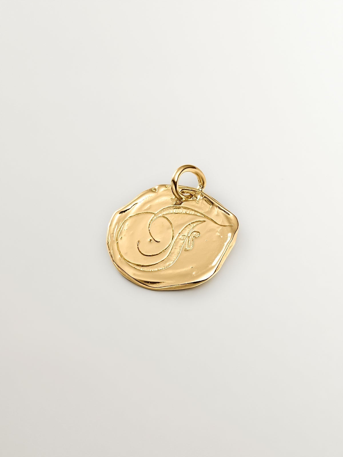 Handcrafted charm made of 925 silver, bathed in 18K yellow gold with initial F.