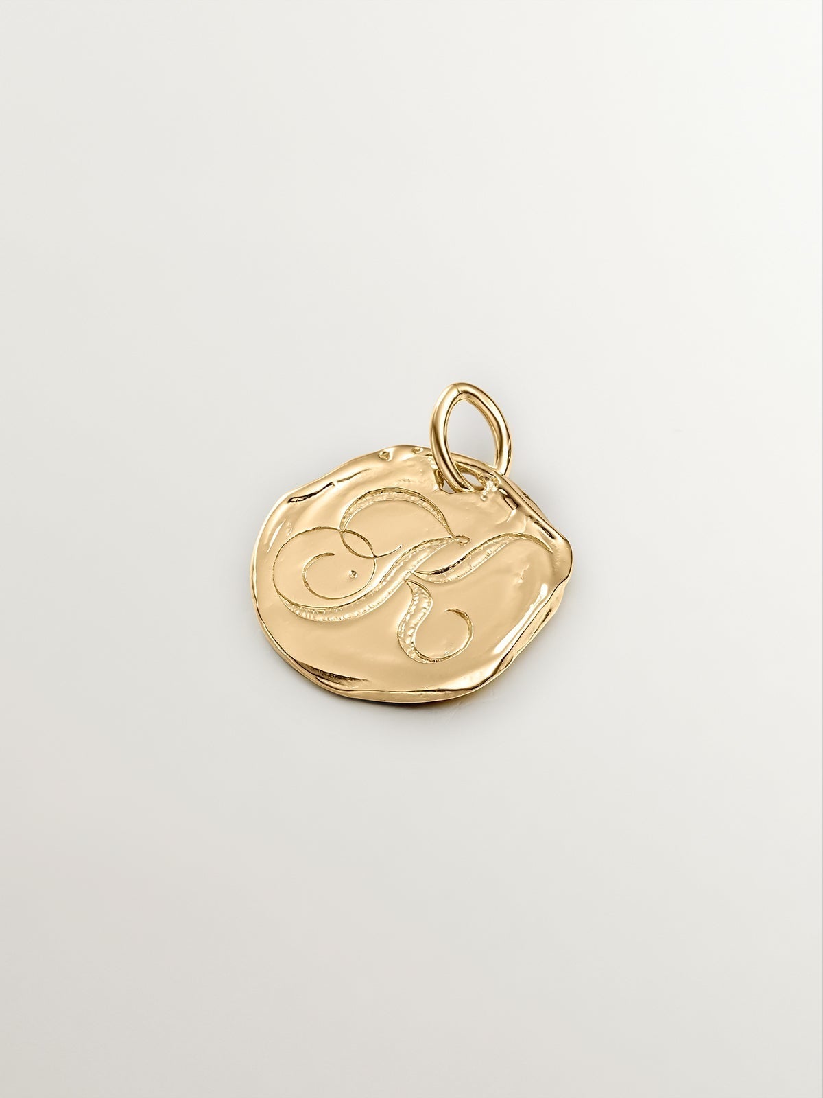 Handcrafted 925 silver charm, bathed in 18K yellow gold with initial K.
