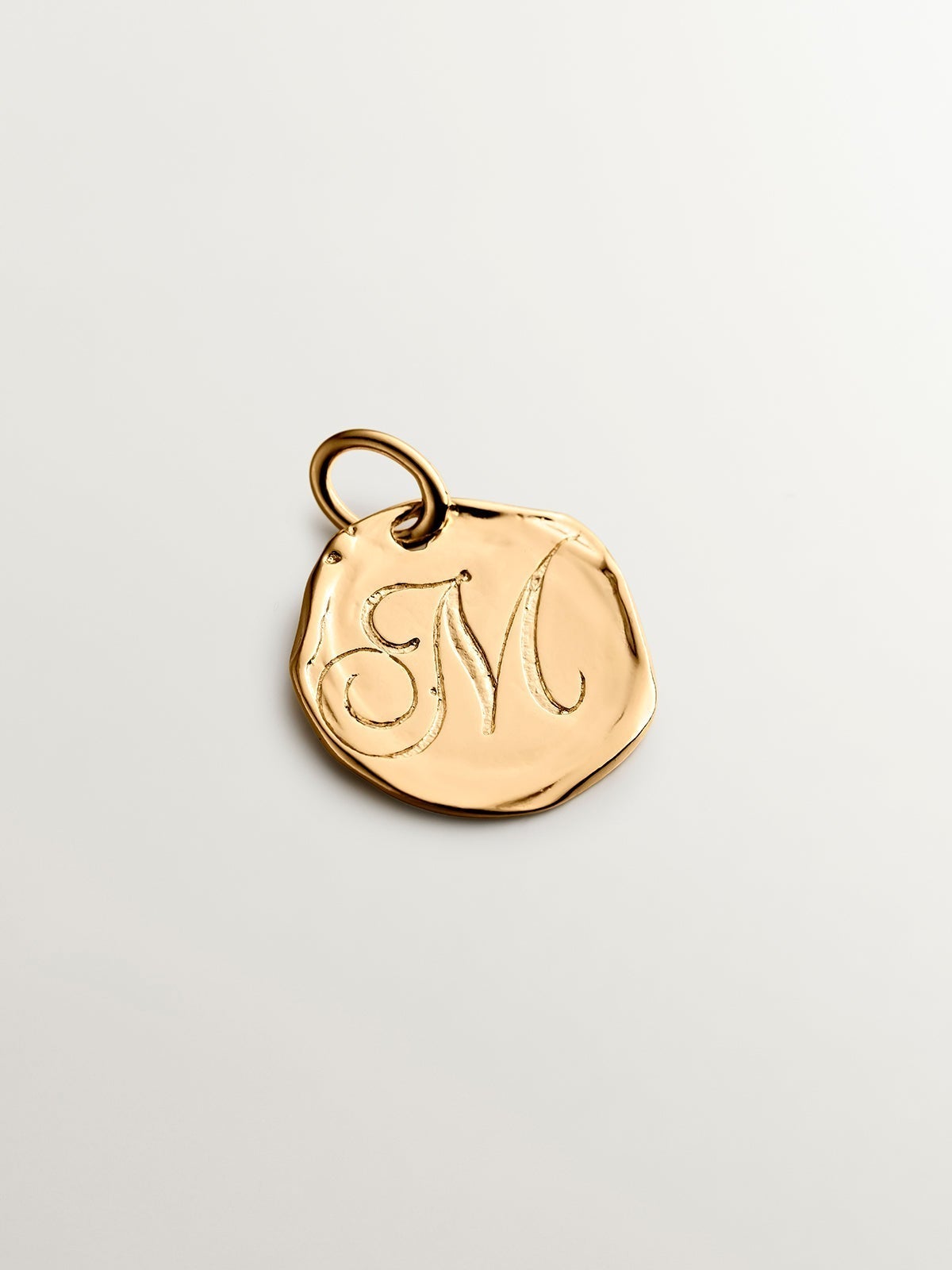 Handcrafted charm made of 925 silver bathed in 18K yellow gold with initial M.
