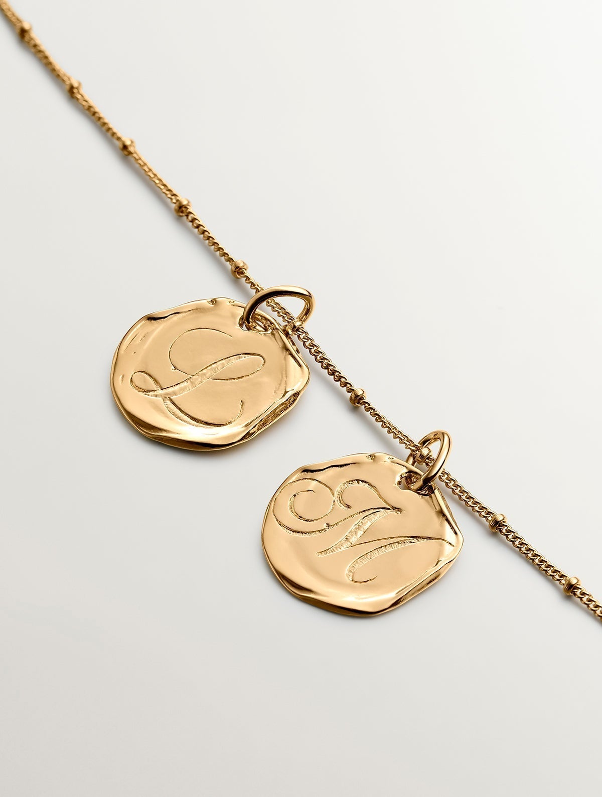 Handcrafted charm made of 925 silver bathed in 18K yellow gold with initial M.