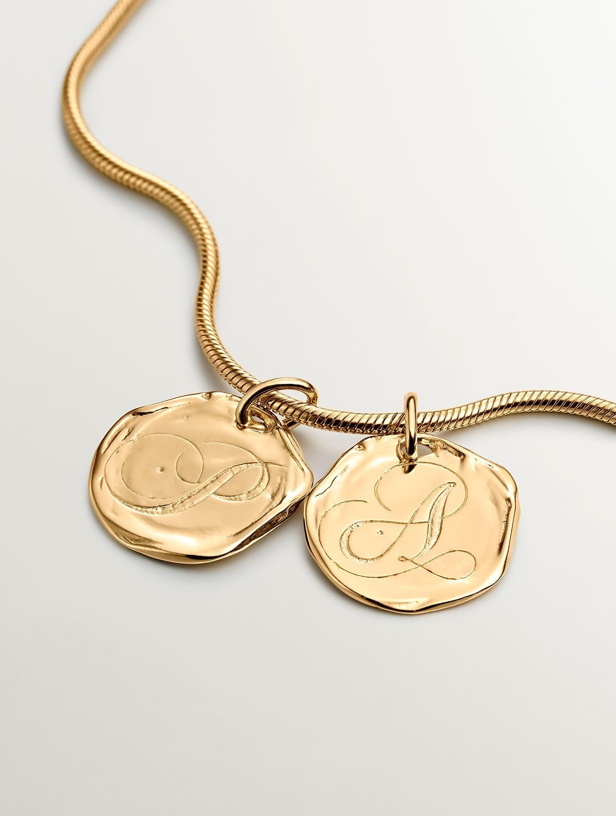 Handcrafted 925 silver charm bathed in 18K yellow gold with initial P.