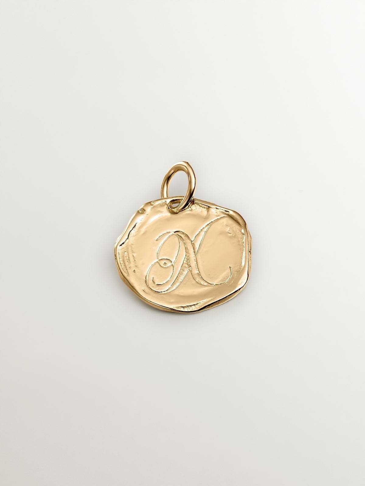 Handcrafted charm made of 925 silver, coated in 18K yellow gold with the initial X.