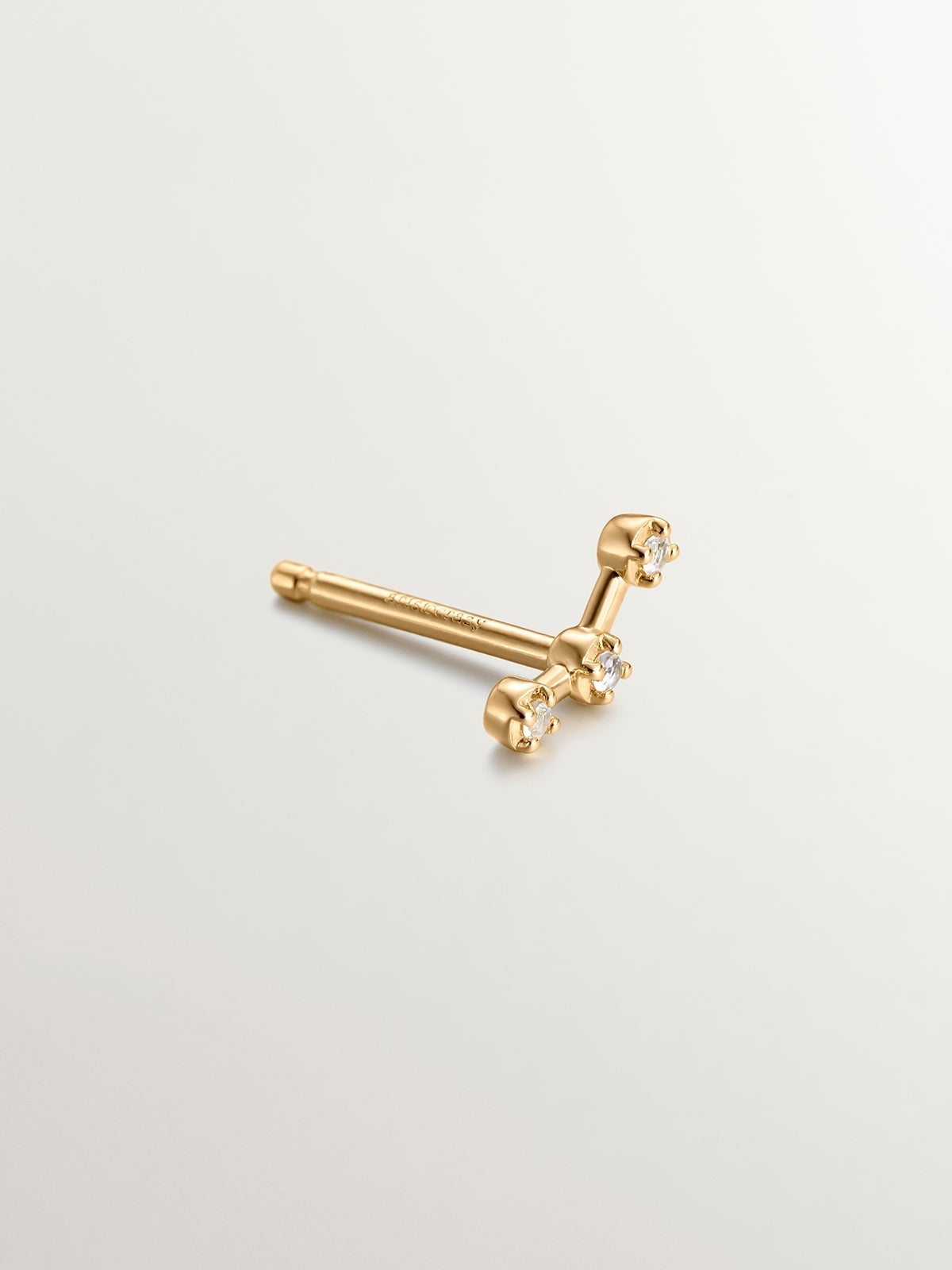 Single climbing earring made of 925 silver coated in 18K yellow gold with white topaz.