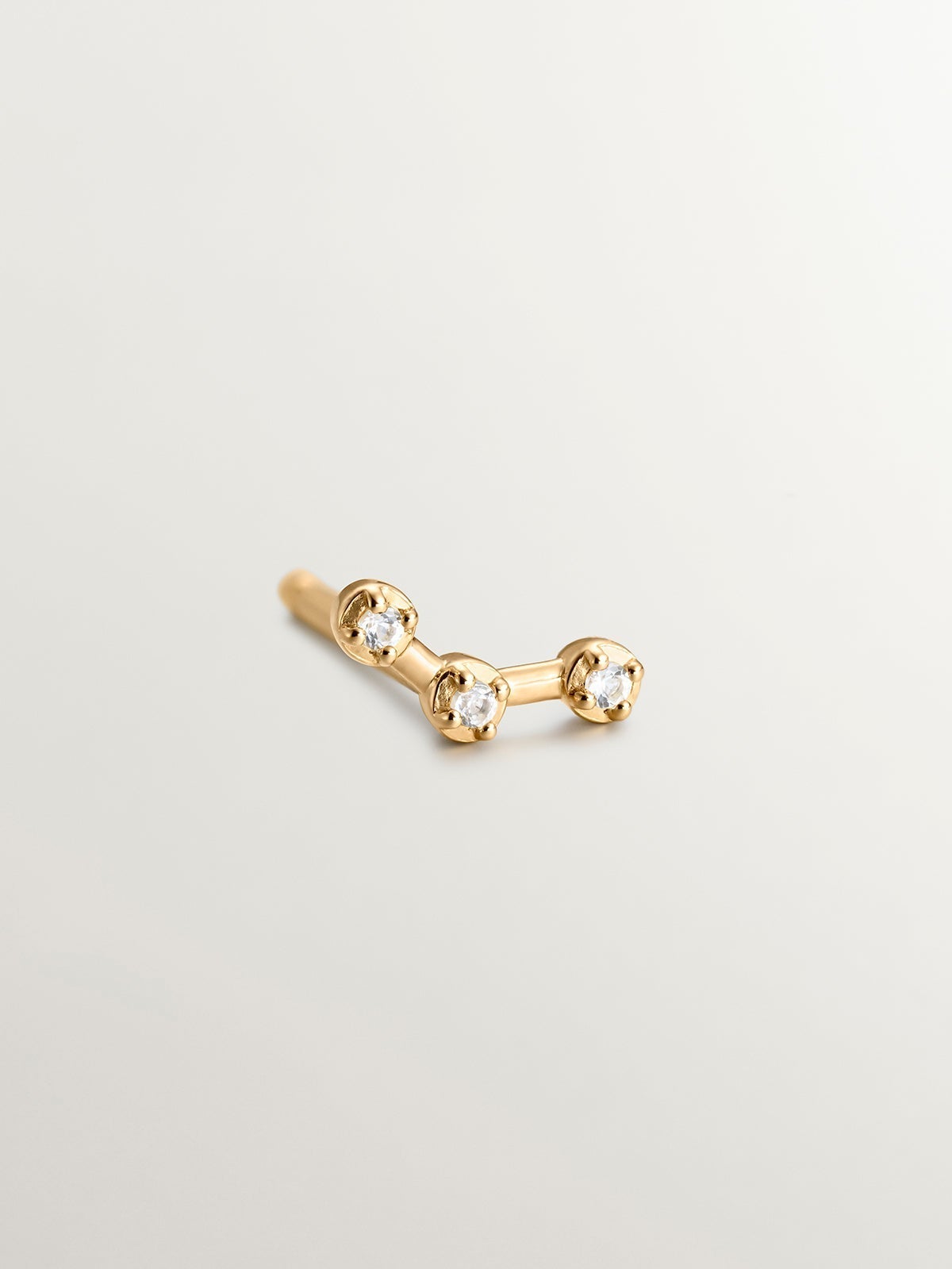Single climbing earring made of 925 silver coated in 18K yellow gold with white topaz.
