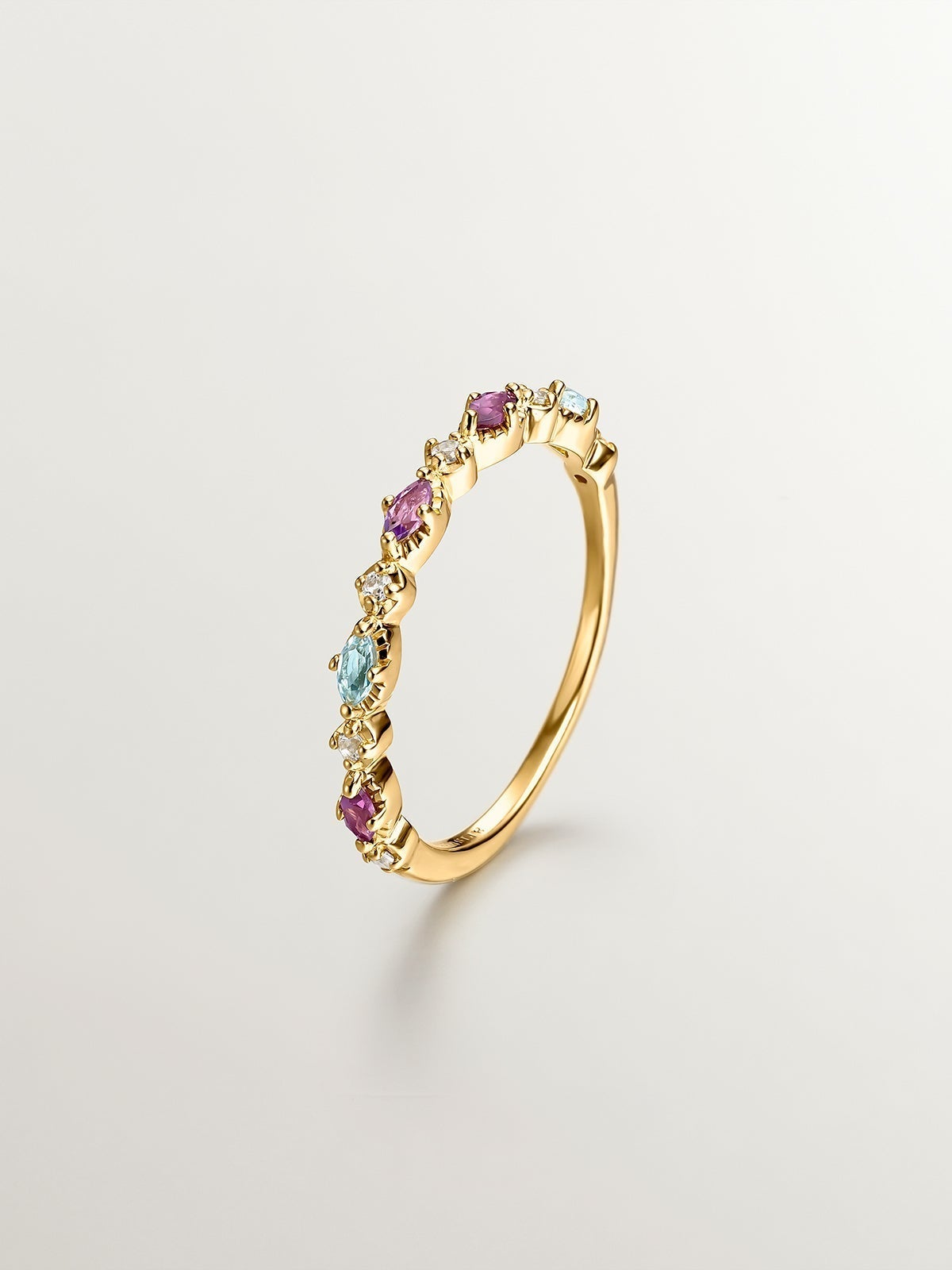 925 Silver ring bathed in 18K yellow gold with topaz, rhodolites, and amethyst.