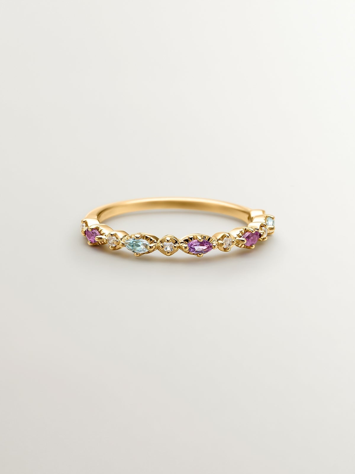 925 Silver ring bathed in 18K yellow gold with topaz, rhodolites, and amethyst.