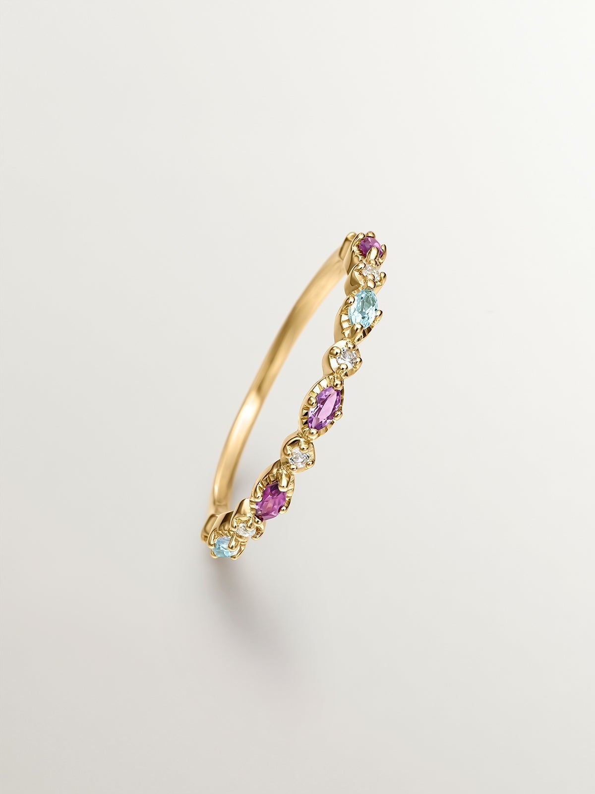 925 Silver ring bathed in 18K yellow gold with topaz, rhodolites, and amethyst.