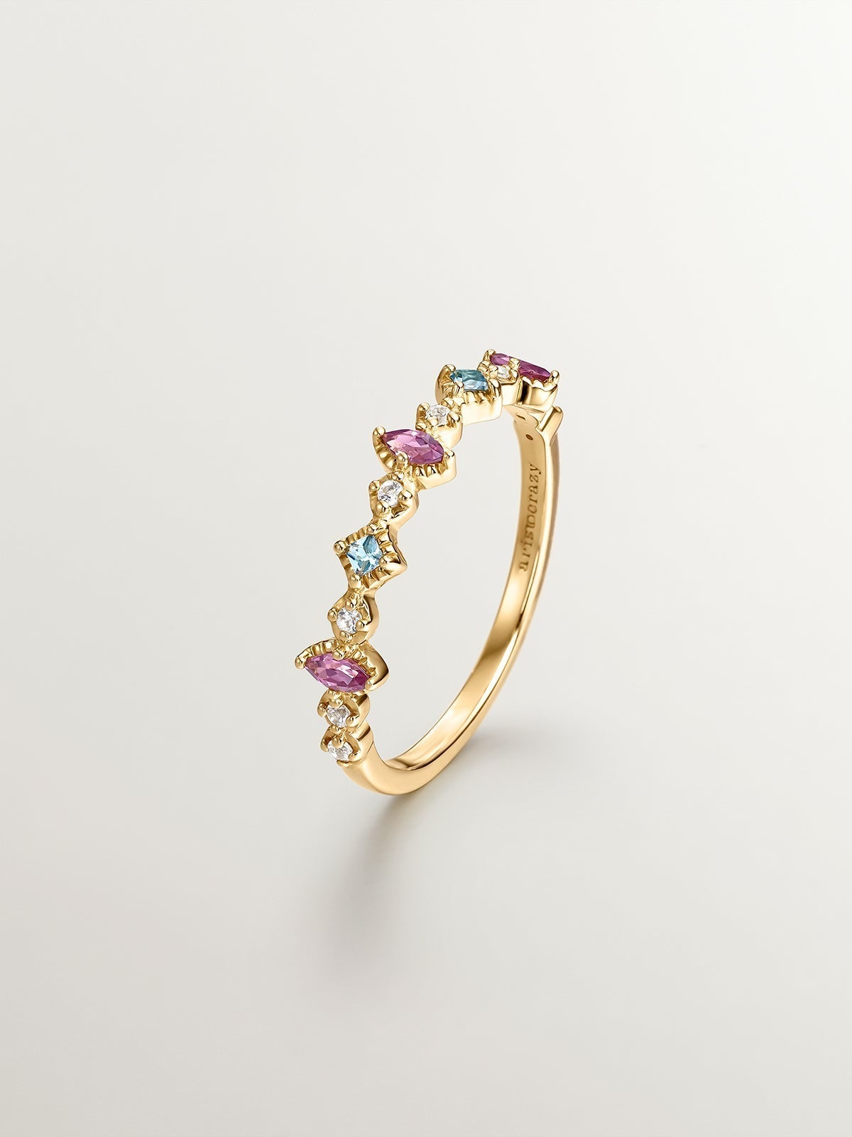 925 Silver ring bathed in 18K yellow gold with topaz and rhodolites.