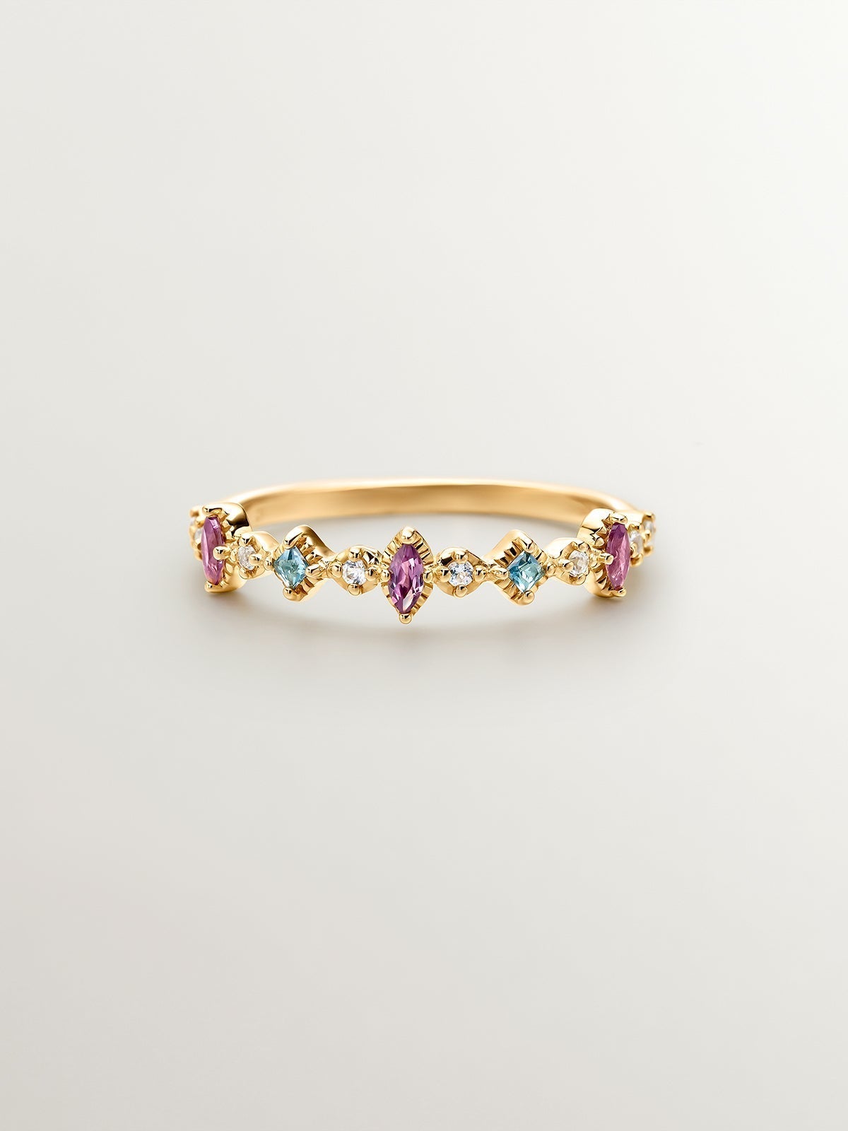 925 Silver ring bathed in 18K yellow gold with topaz and rhodolites.