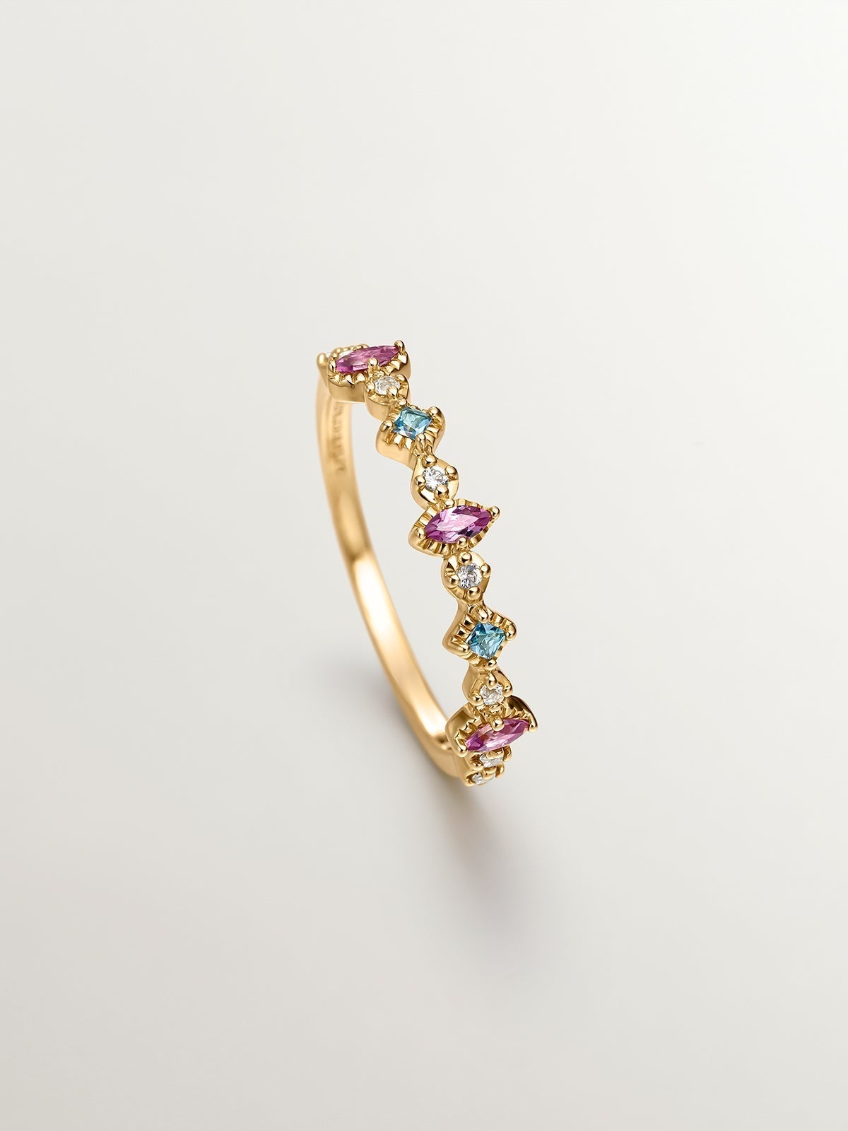 925 Silver ring bathed in 18K yellow gold with topaz and rhodolites.