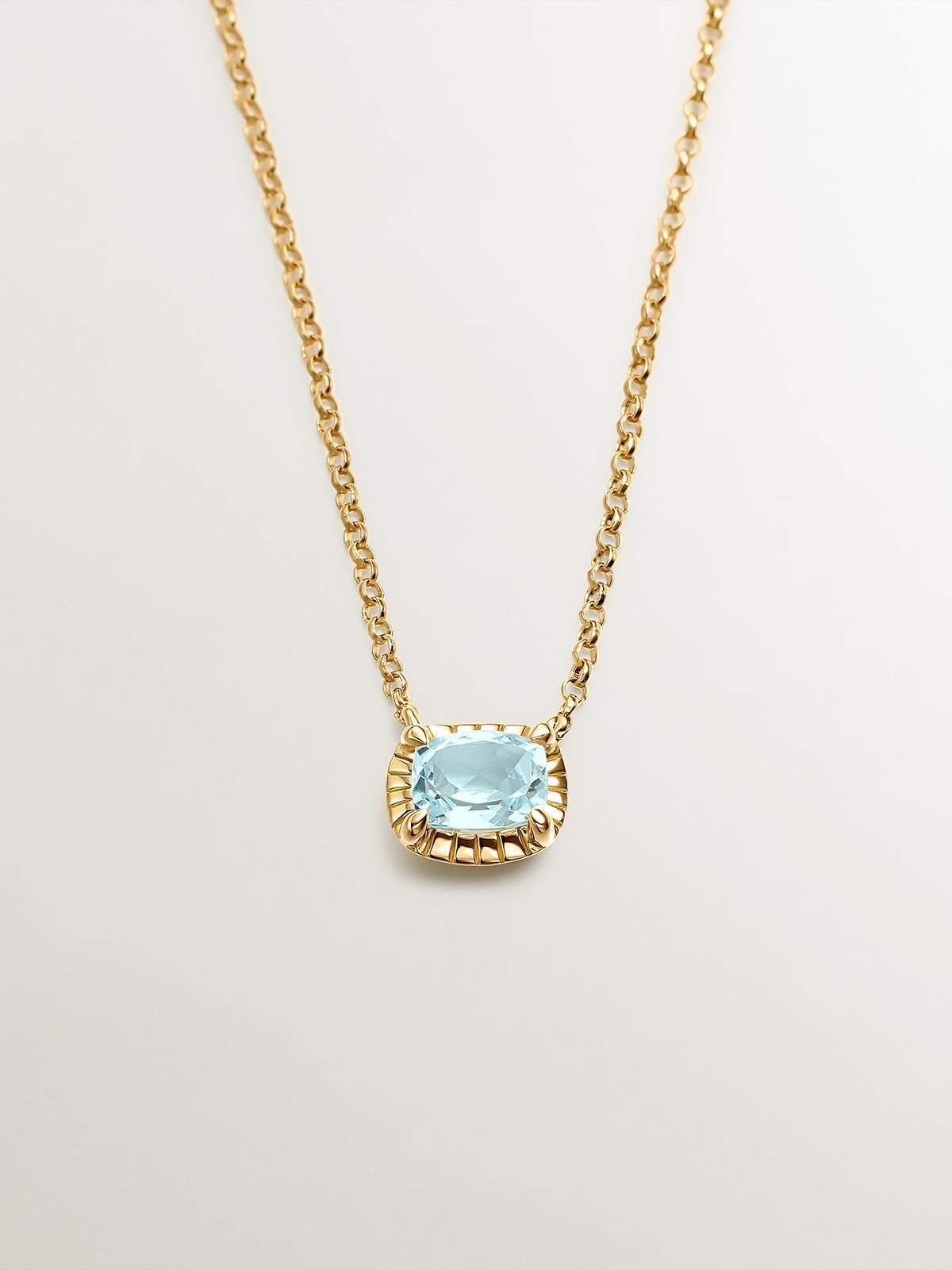925 Silver pendant bathed in 18K yellow gold with sky blue topaz.