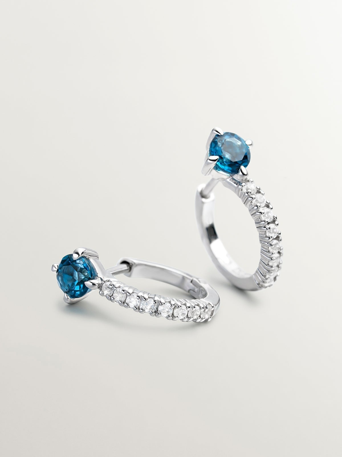 925 Silver hoop earrings with blue and white topaz.