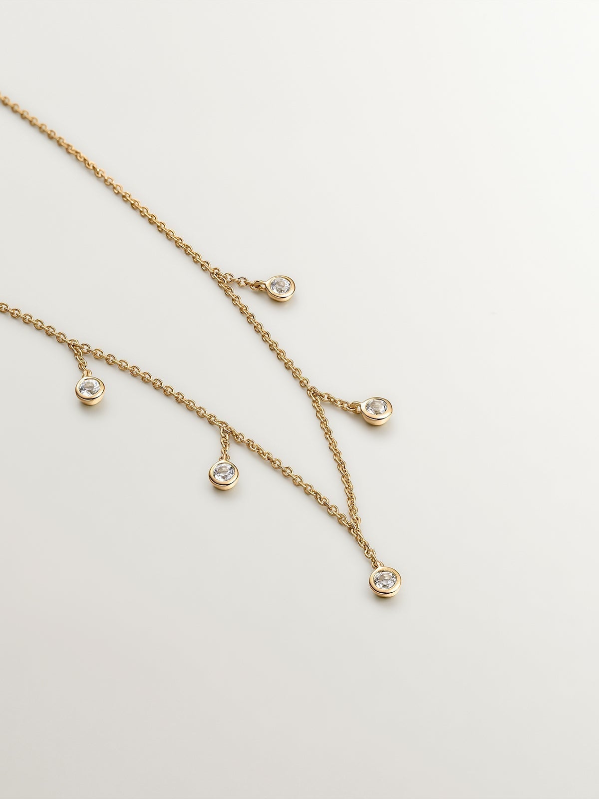 925 silver necklace bathed in 18K yellow gold with white topaz stones