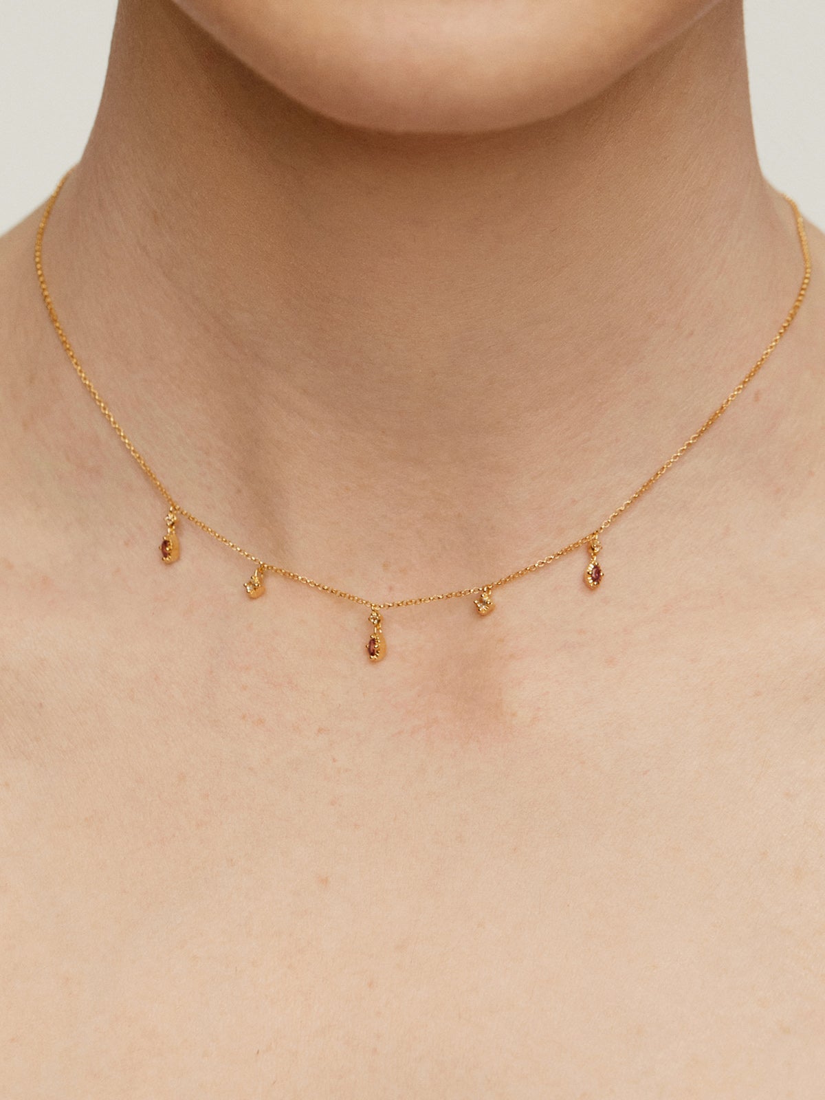 925 Silver necklace coated in 18K yellow gold with rhodolites and topazes.