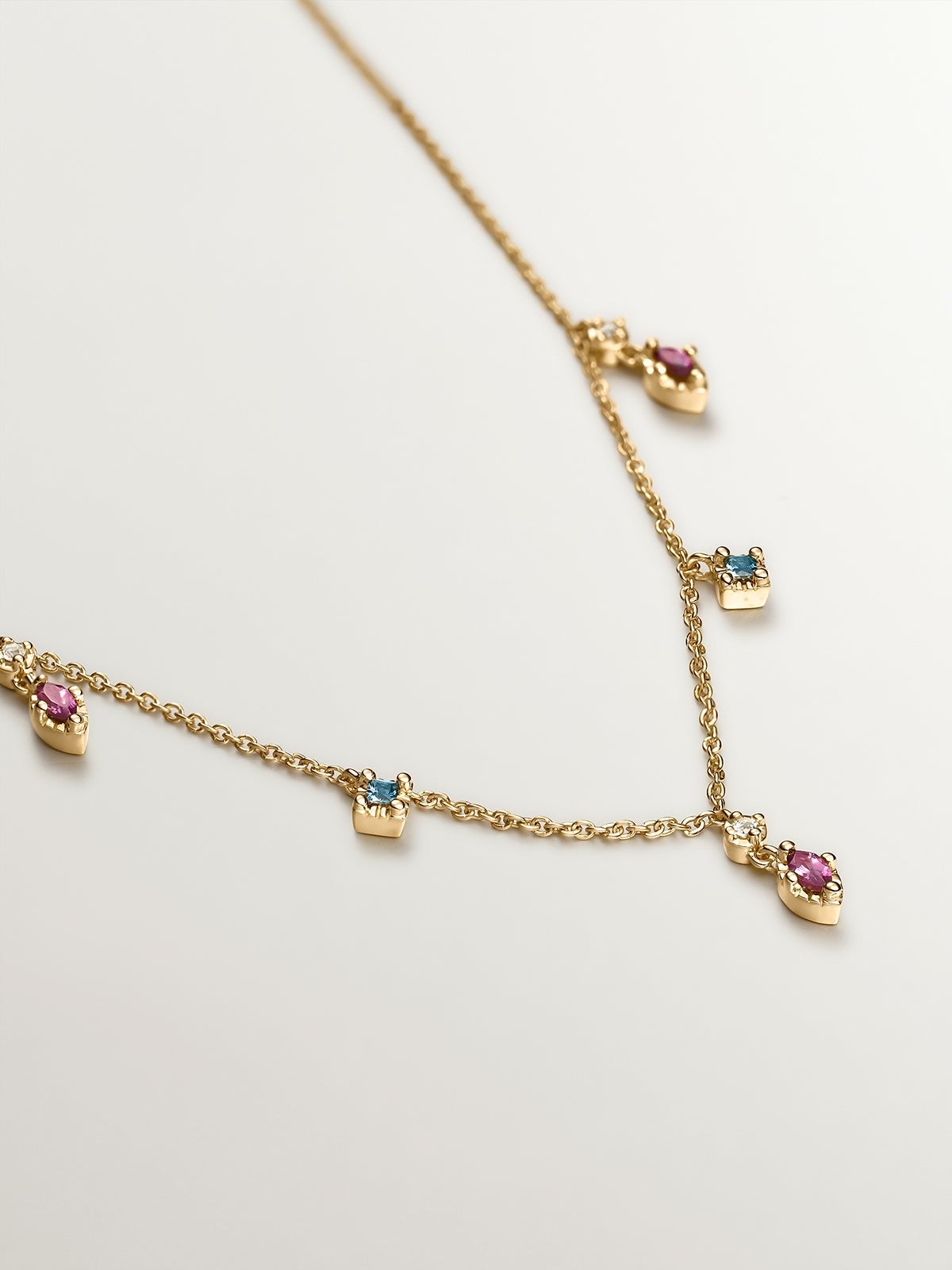 925 Silver necklace coated in 18K yellow gold with rhodolites and topazes.