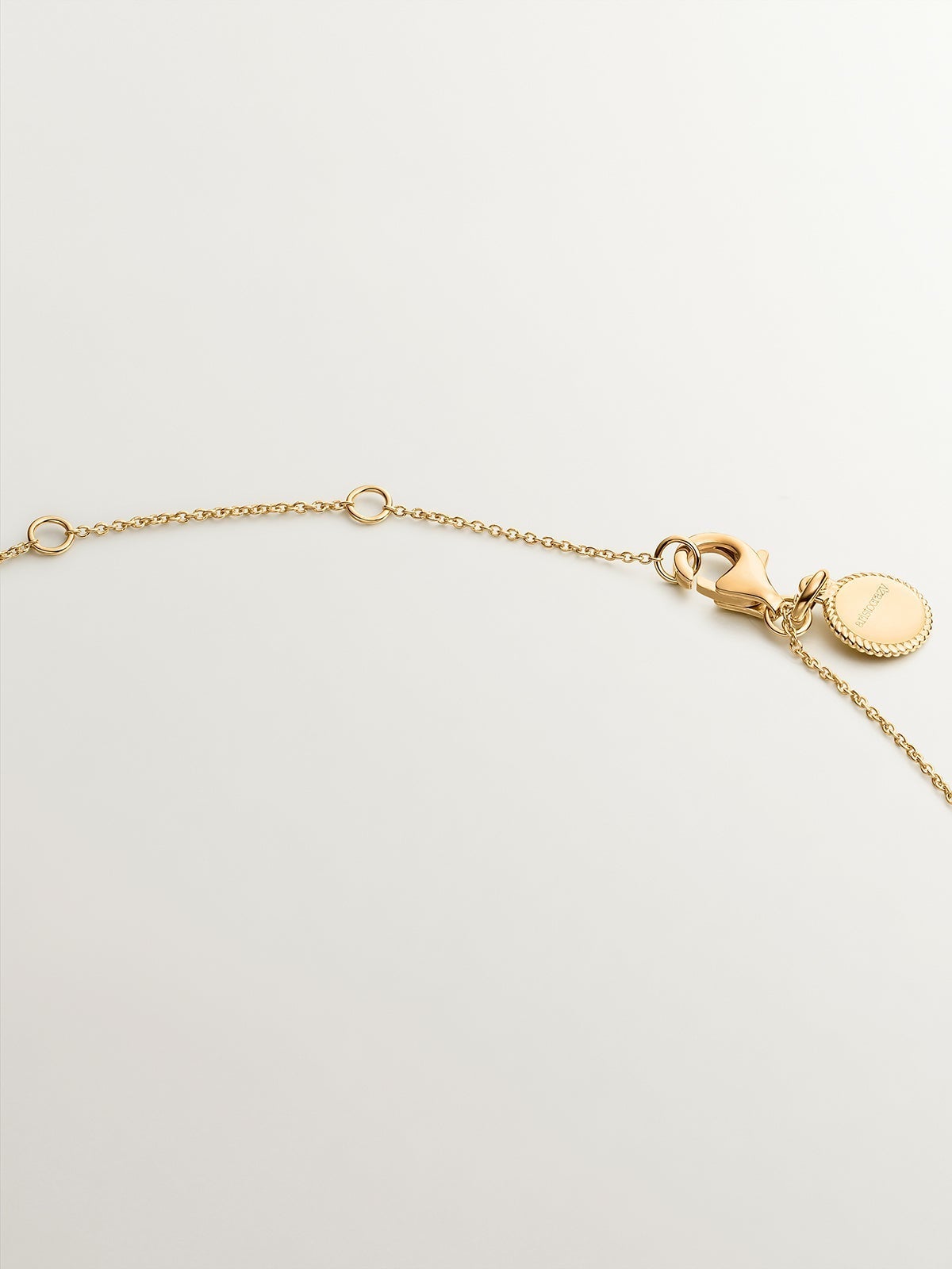 925 Silver necklace coated in 18K yellow gold with rhodolites and topazes.