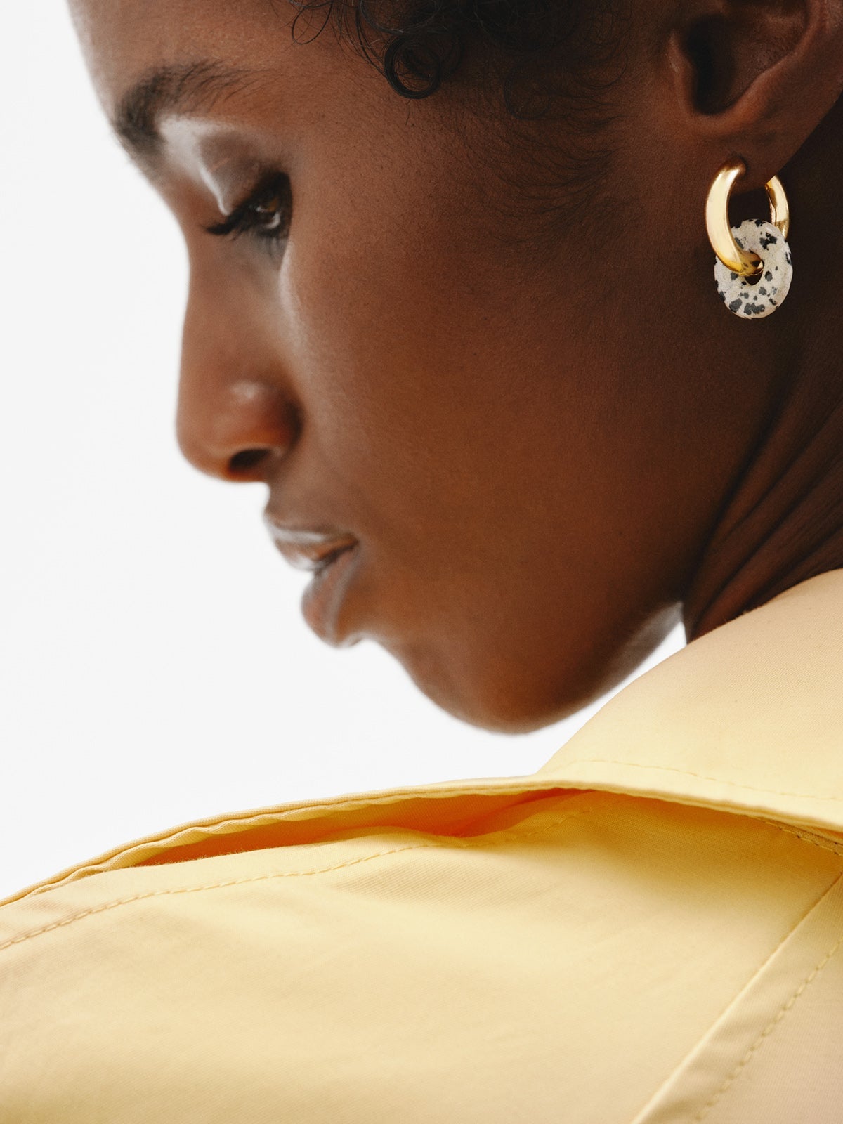 925 sterling silver medium hoop earrings with 18K yellow gold plating featuring dalmatian jasper.