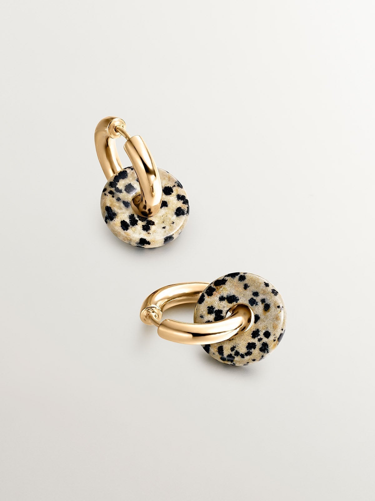 925 sterling silver medium hoop earrings with 18K yellow gold plating featuring dalmatian jasper.