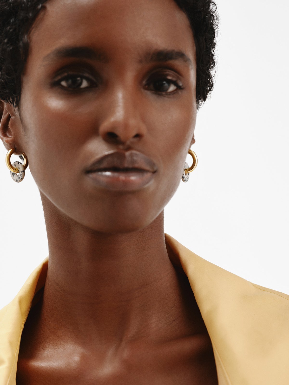 925 sterling silver medium hoop earrings with 18K yellow gold plating featuring dalmatian jasper.