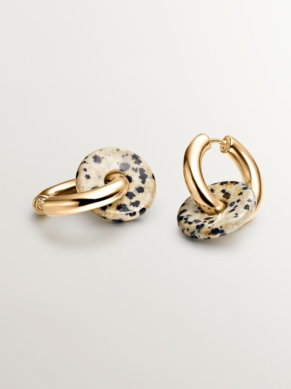 925 sterling silver medium hoop earrings with 18K yellow gold plating featuring dalmatian jasper.