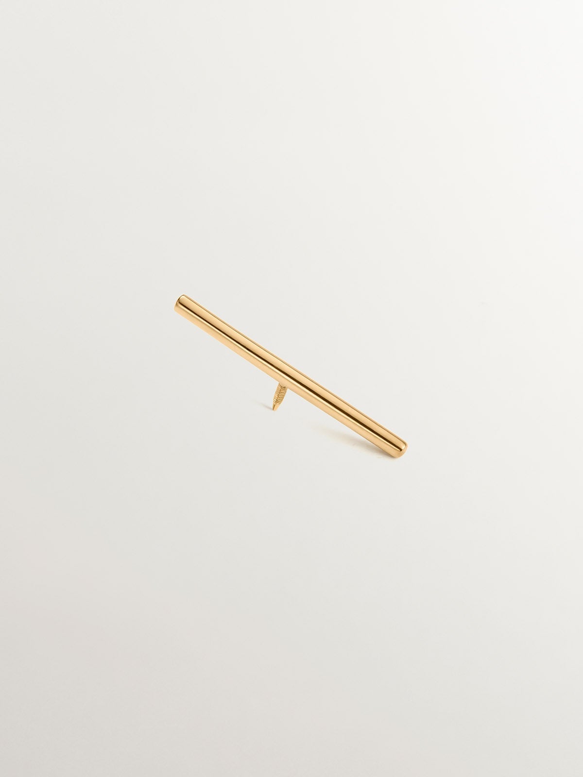 18K yellow gold industrial bar piercing