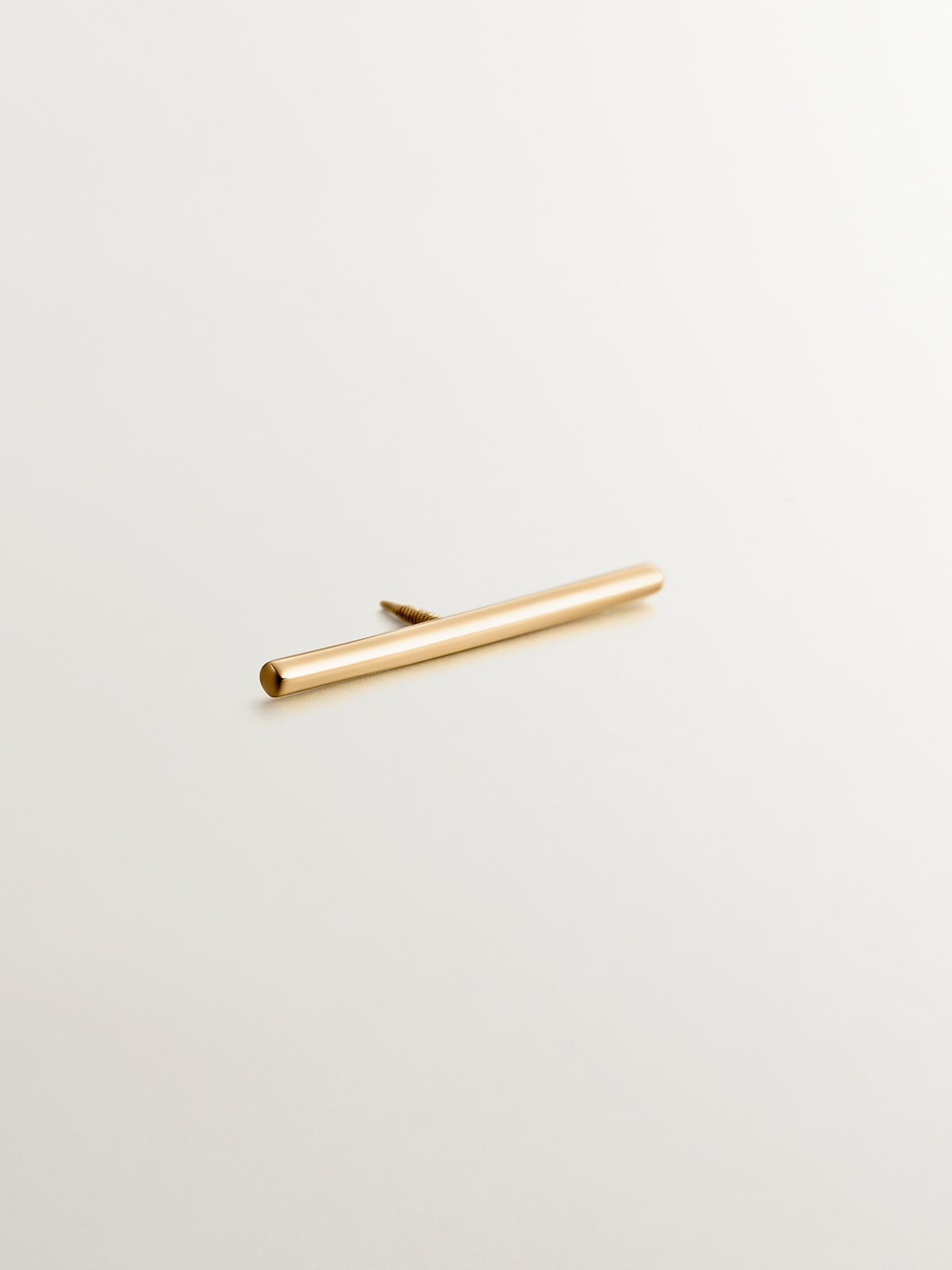 18K yellow gold industrial bar piercing