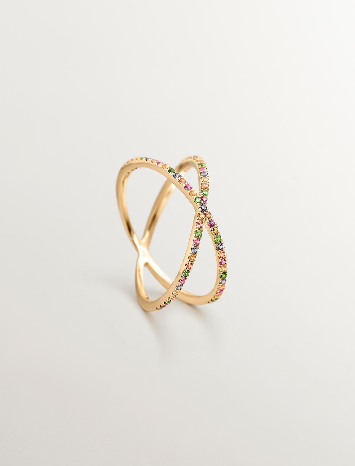 Double crossed 9K yellow gold ring with tsavorites and multicolor sapphires.