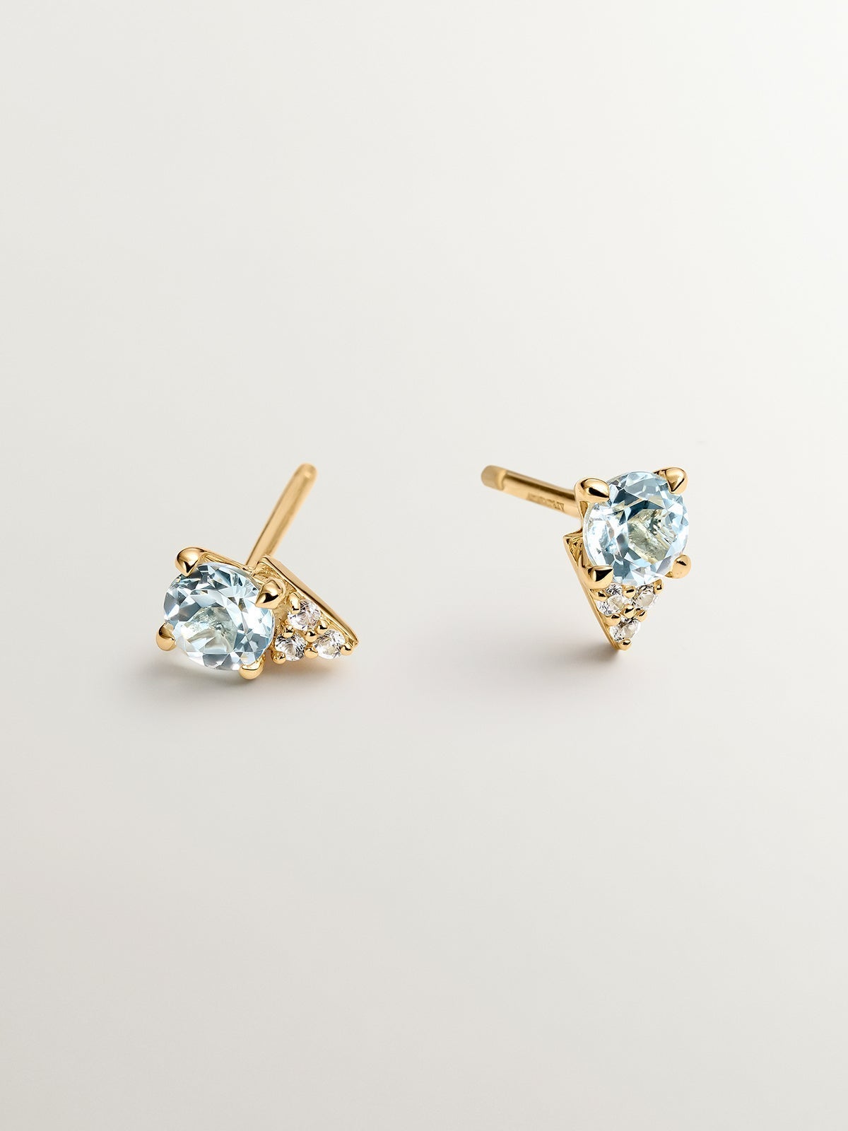 925 Silver earrings bathed in 18K yellow gold with sky blue topaz and white sapphires.