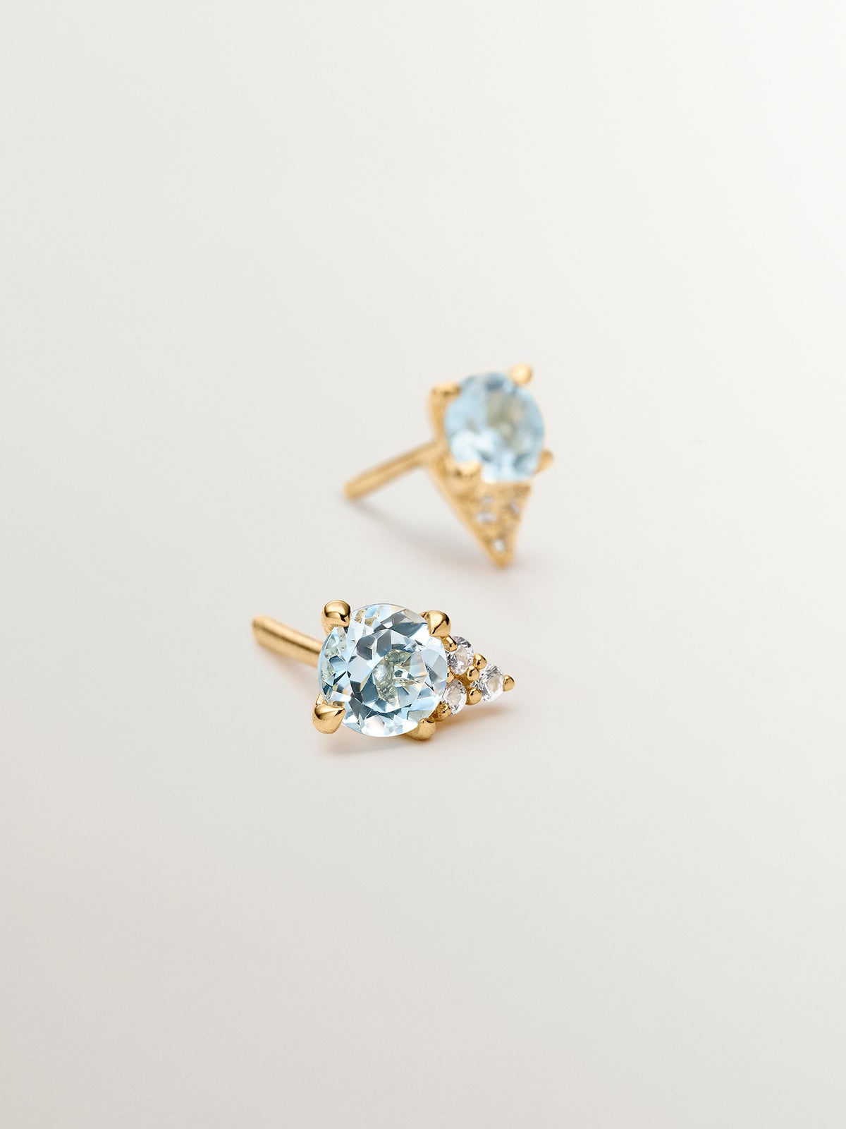 925 Silver earrings bathed in 18K yellow gold with sky blue topaz and white sapphires.