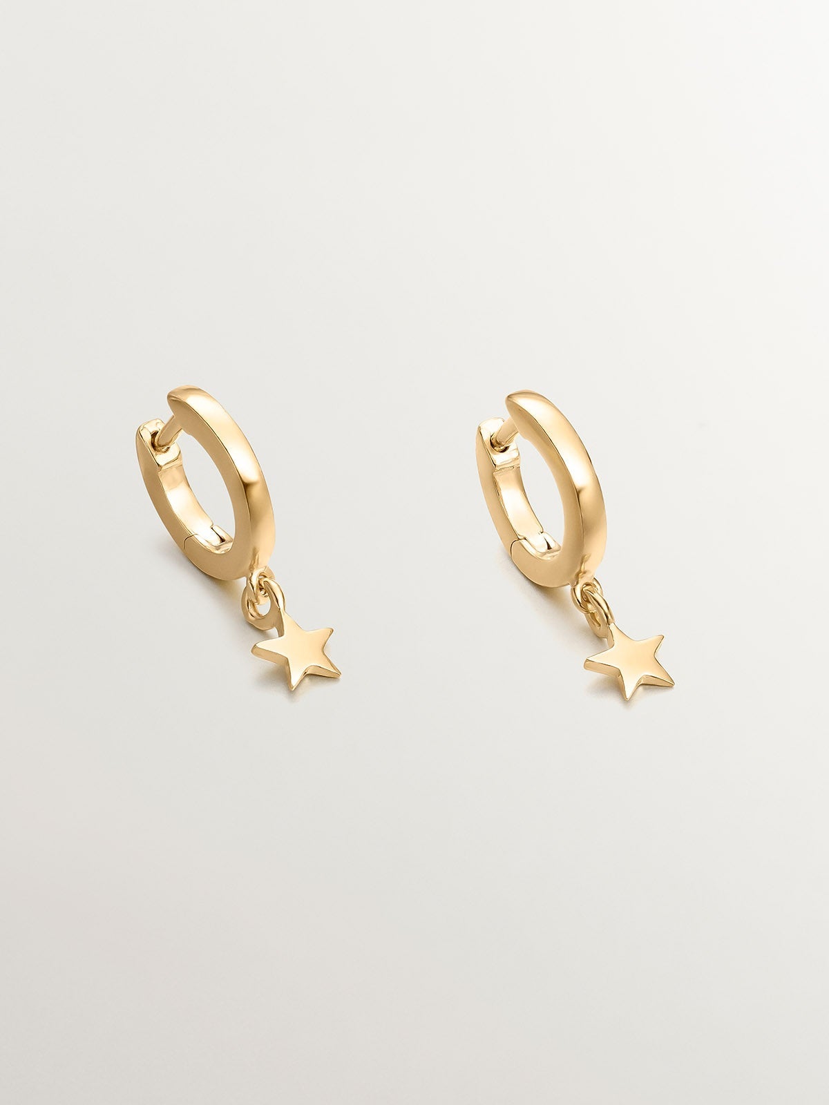 Small hoop earrings made of 925 silver, bathed in 18K yellow gold with star.