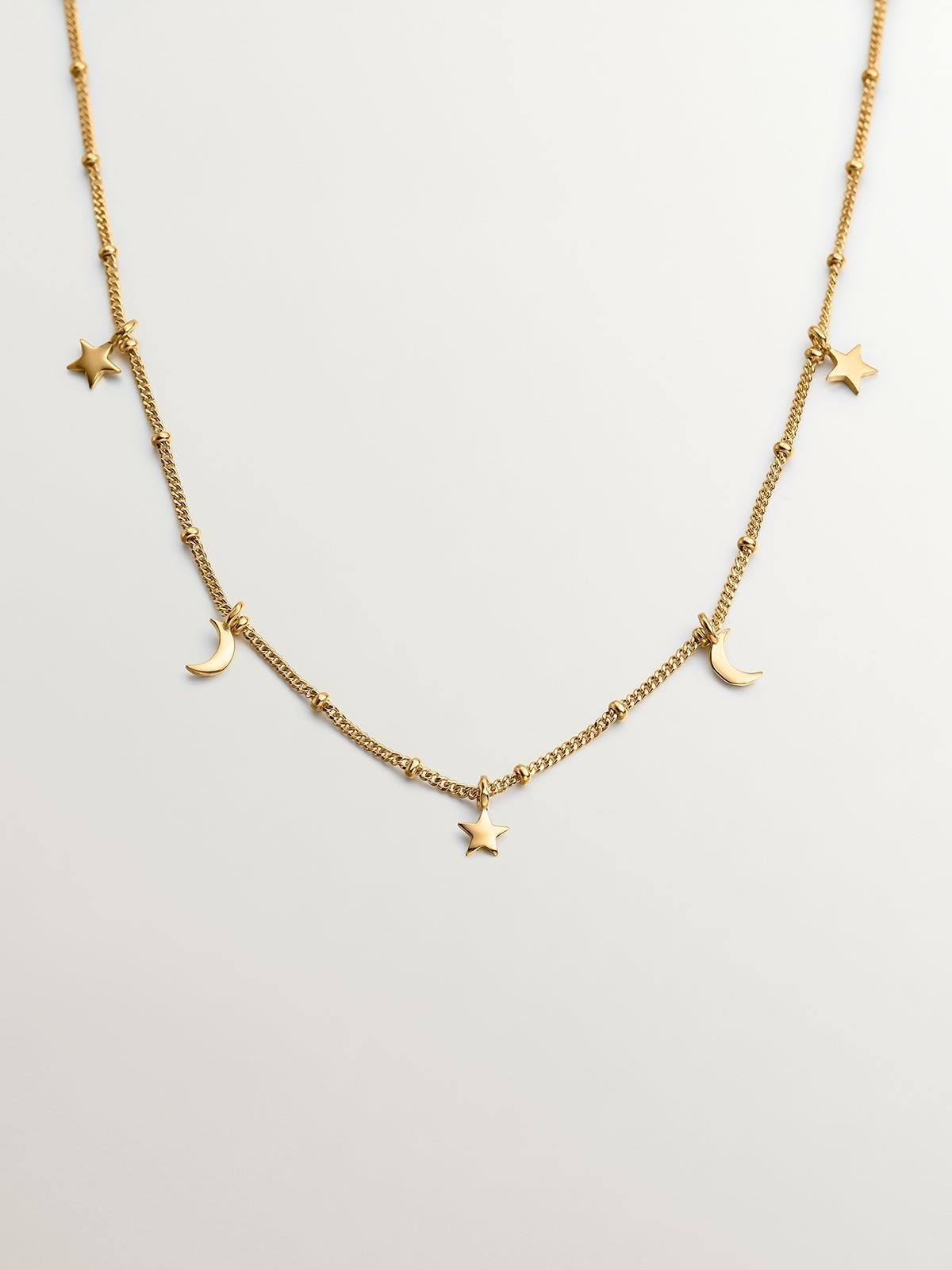 925 Silver necklace coated in 18K yellow gold with stars and moons.