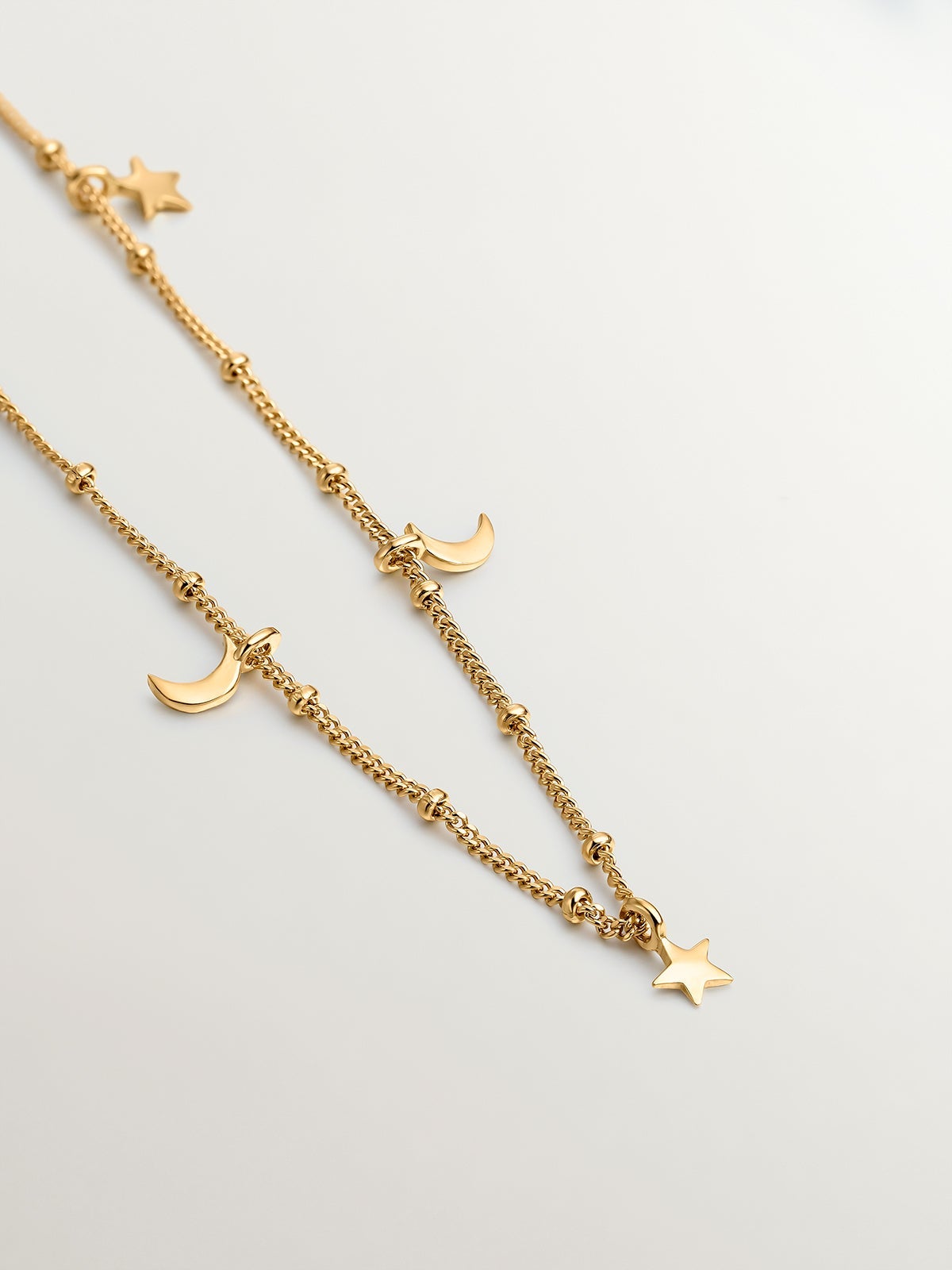 925 Silver necklace coated in 18K yellow gold with stars and moons.