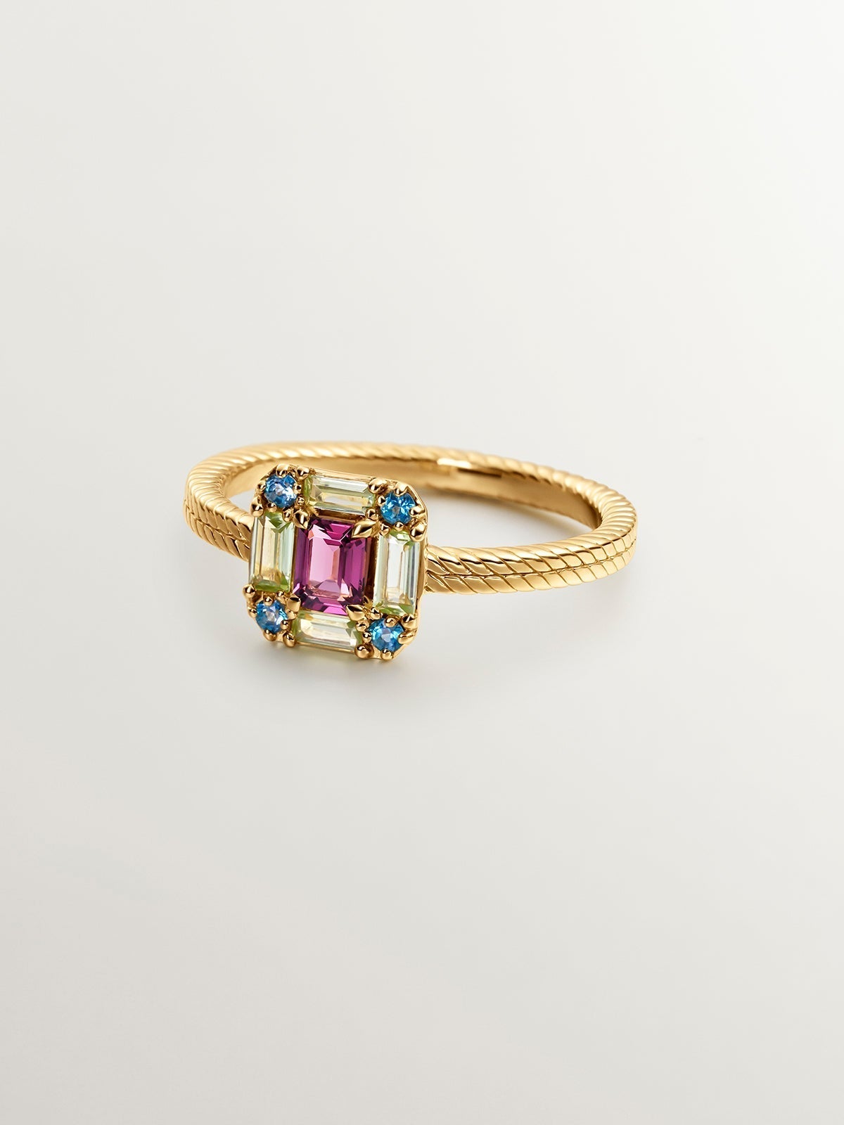 925 Silver ring bathed in 18K yellow gold with rhodolite, peridot, and topaz.