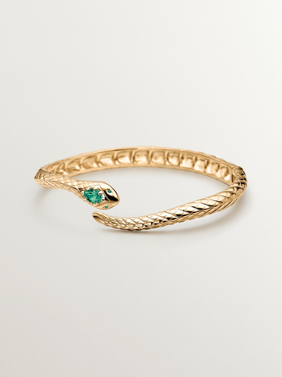 Rigid bracelet made of 925 silver plated in 18K yellow gold with green onyx and shaped like a snake