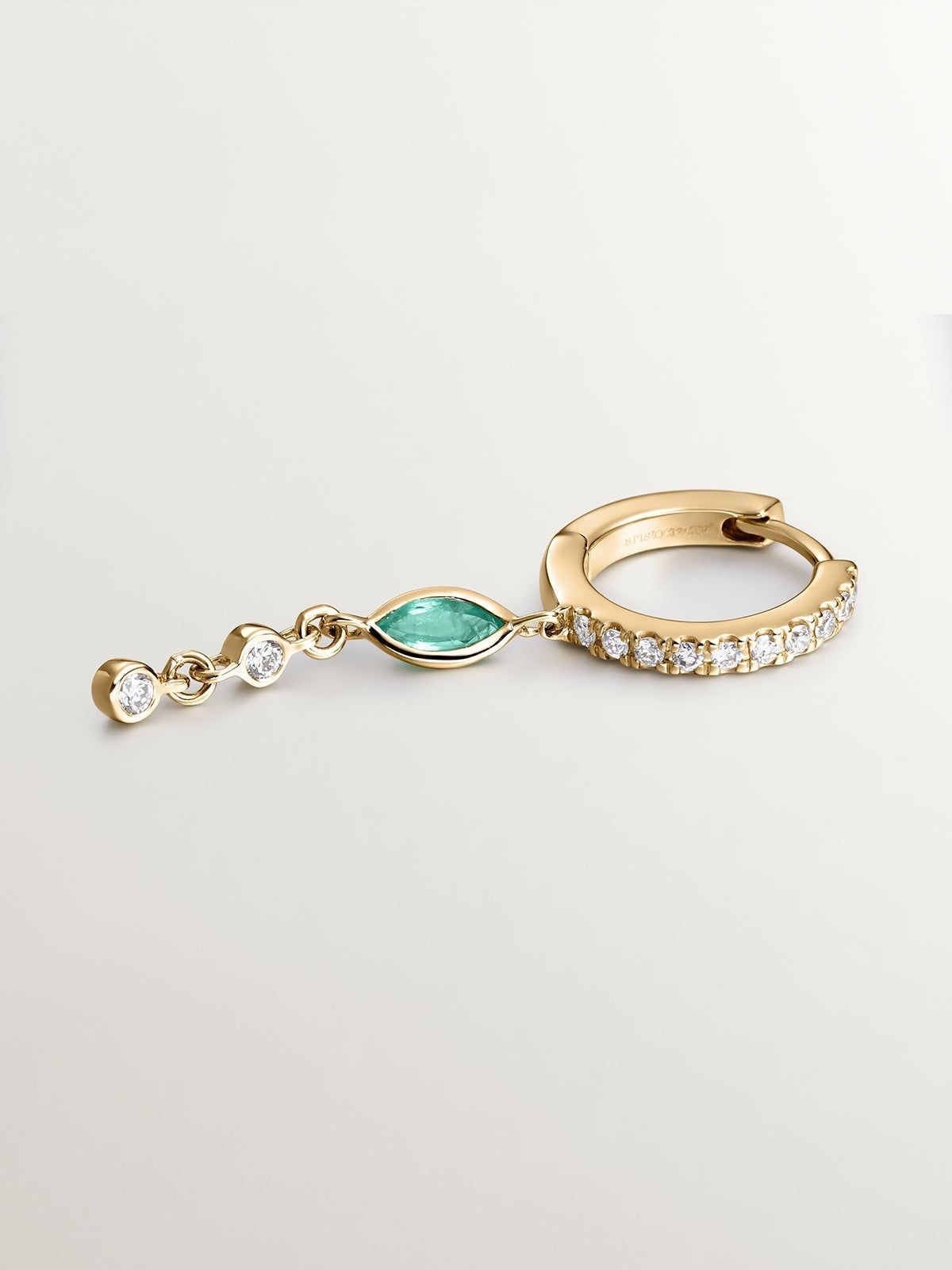 Individual small hoop earring made of 9K yellow gold with a diamond chain and emerald.
