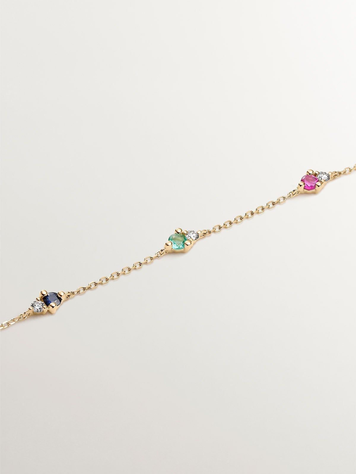 9K yellow gold bracelet with sapphire, emerald, ruby, and diamonds.