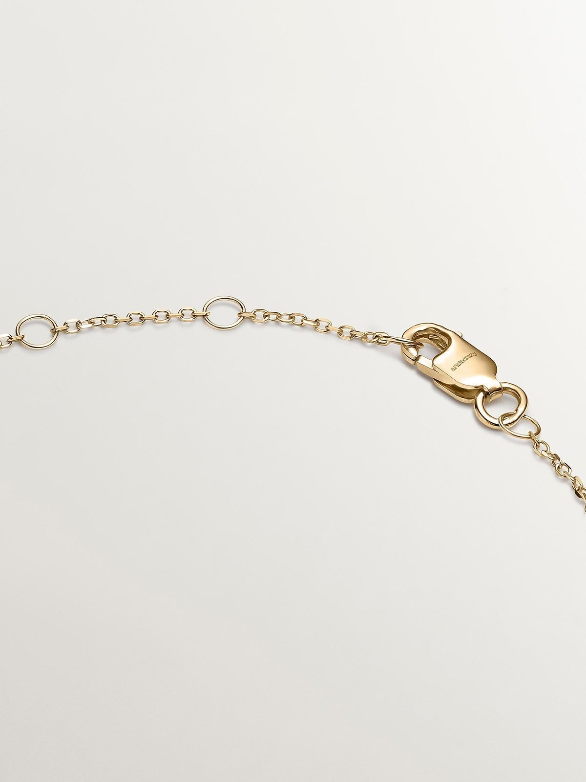 9K yellow gold bracelet with sapphire, emerald, ruby, and diamonds.
