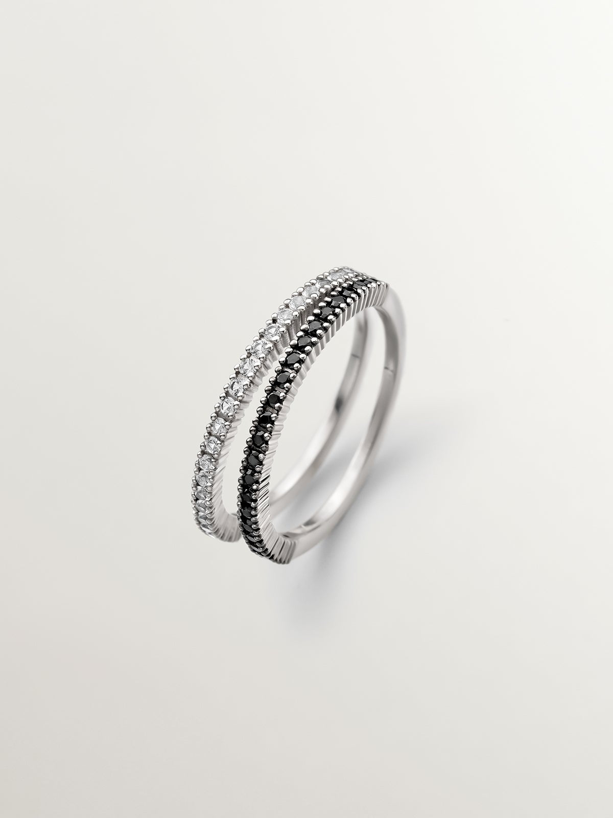 Double ring made of 925 silver with black spinels and white topaz.
