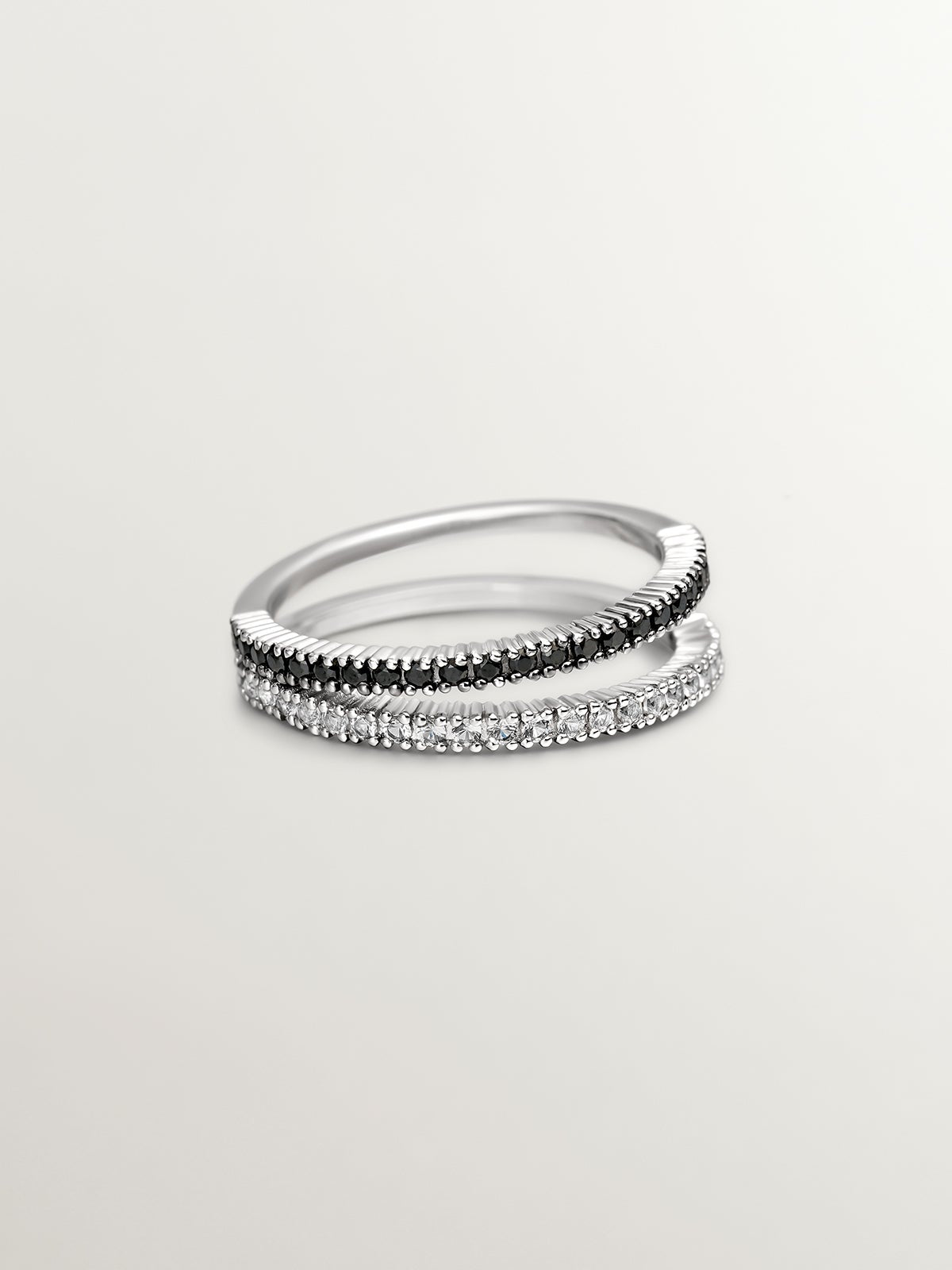 Double ring made of 925 silver with black spinels and white topaz.