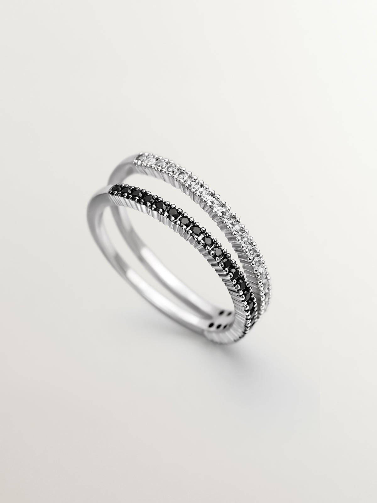 Double ring made of 925 silver with black spinels and white topaz.