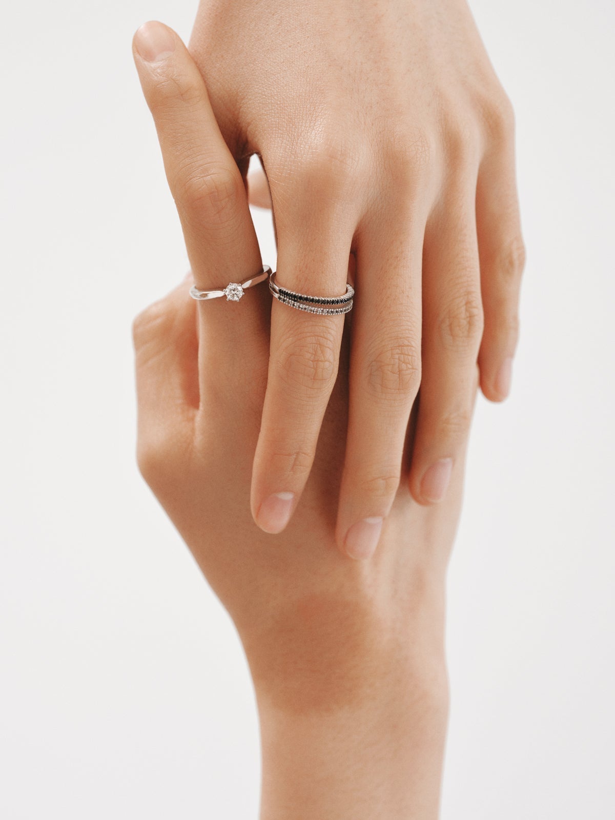 Double ring made of 925 silver with black spinels and white topaz.